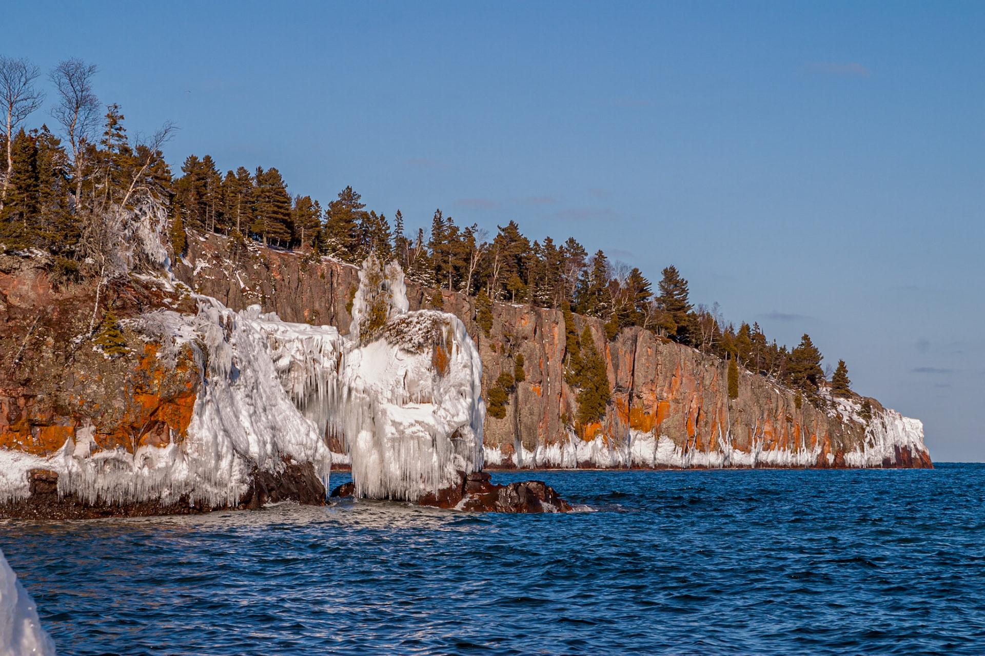 April 11 - Shovel PointSpringtime is returning to the Northland as winter begins to lose its icy grip. The combination of ice, orange lichen, blues of the water, and forest green paints a tapestry of early spring.Soon, the warm summer breezes will dissolve the ice away next year."For ye shall go out with joy, and be led forth with peace: the mountains and the hills shall break forth before you into singing, and all the trees of the field shall clap their hands." Isaiah 55:12 Today is the day that the Lord has made. Enjoy it.