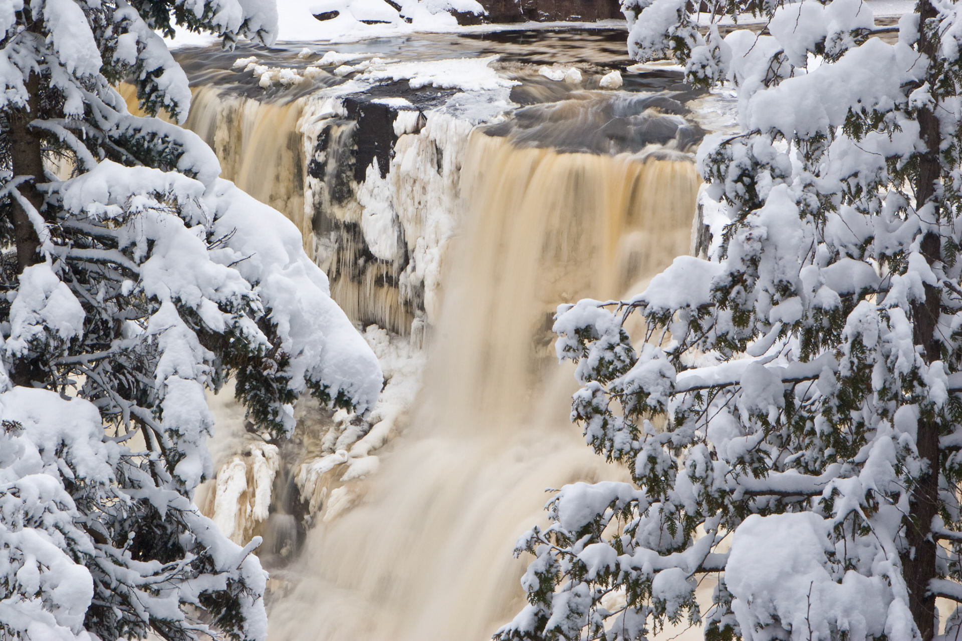 April 5 - April Snow at Gooseberry FallsA mid-April snowstorm blanketed Gooseberry Falls with a beautiful coat of fresh snow. Then he showed me a river of the water of life, clear as crystal, coming from the throne of God and of the Lamb. Revelation 22:1A clean, fresh snowfall is lovely to enjoy any time of year.