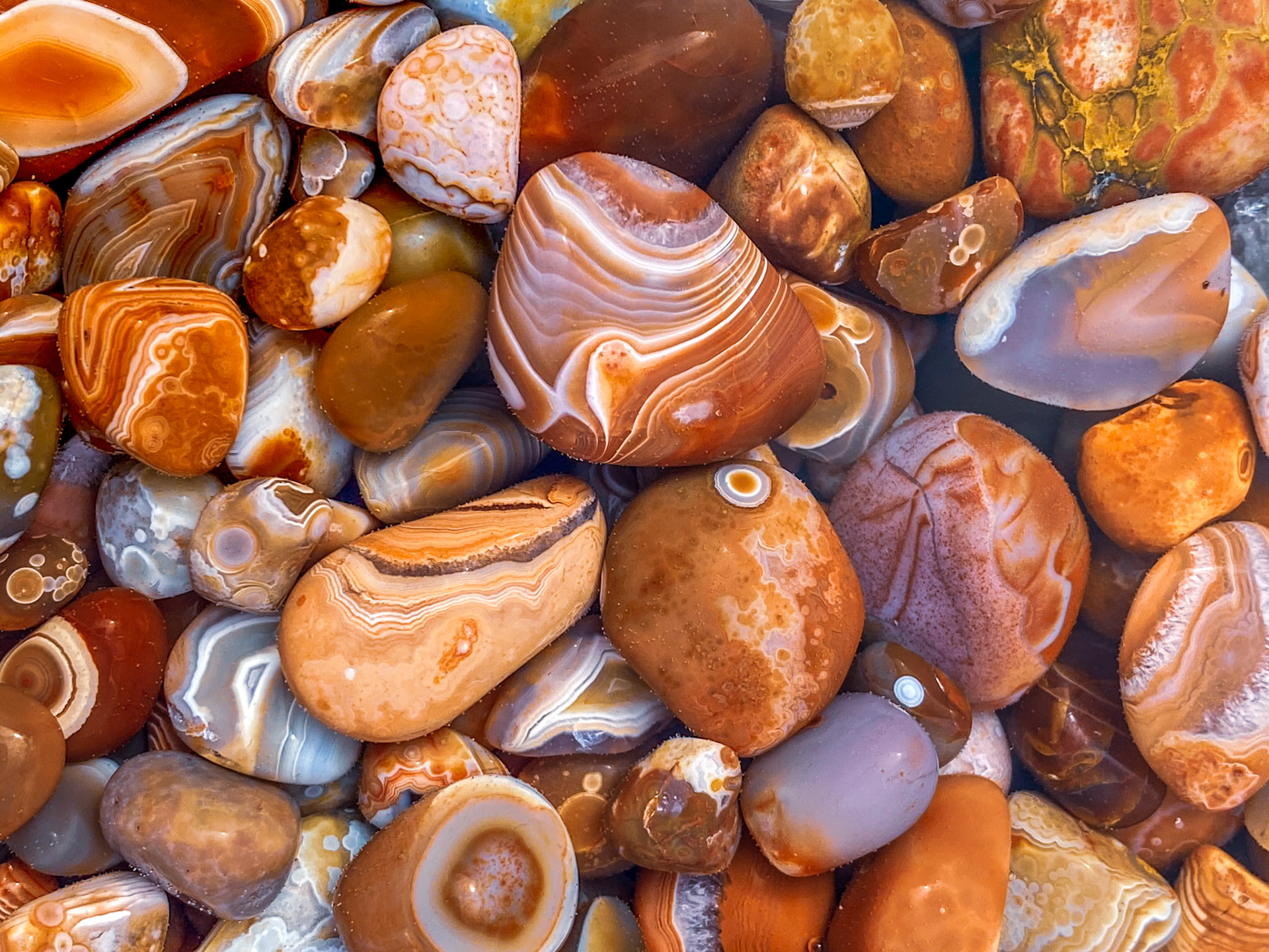 September 8 - Lake Superior AgatesFresh out of the rock tumbler, these Lake Superior Agates display a stunning beauty that the state gemstone of Minnesota correctly recognizes.The multi-banded layers of quartz combine in an unusual display of color rarely seen in the natural world. Often, the inner beauty of agates is revealed by the wave action of Lake Superior, and the gems are found along the shores of the big lake. Often, agates are buried in gravel deposits for years until they are unearthed by an excavation and discovered by a local rockhound.The process of polishing the original agates in a rock tumbler takes many months, with the resulting stone a beauty to behold.Come, let us sing for joy to the Lord; let us shout aloud to the Rock of our salvation. Psalm 95:1Much like the agate, the true beauty of a person is sometimes only revealed after some very rough times in life.