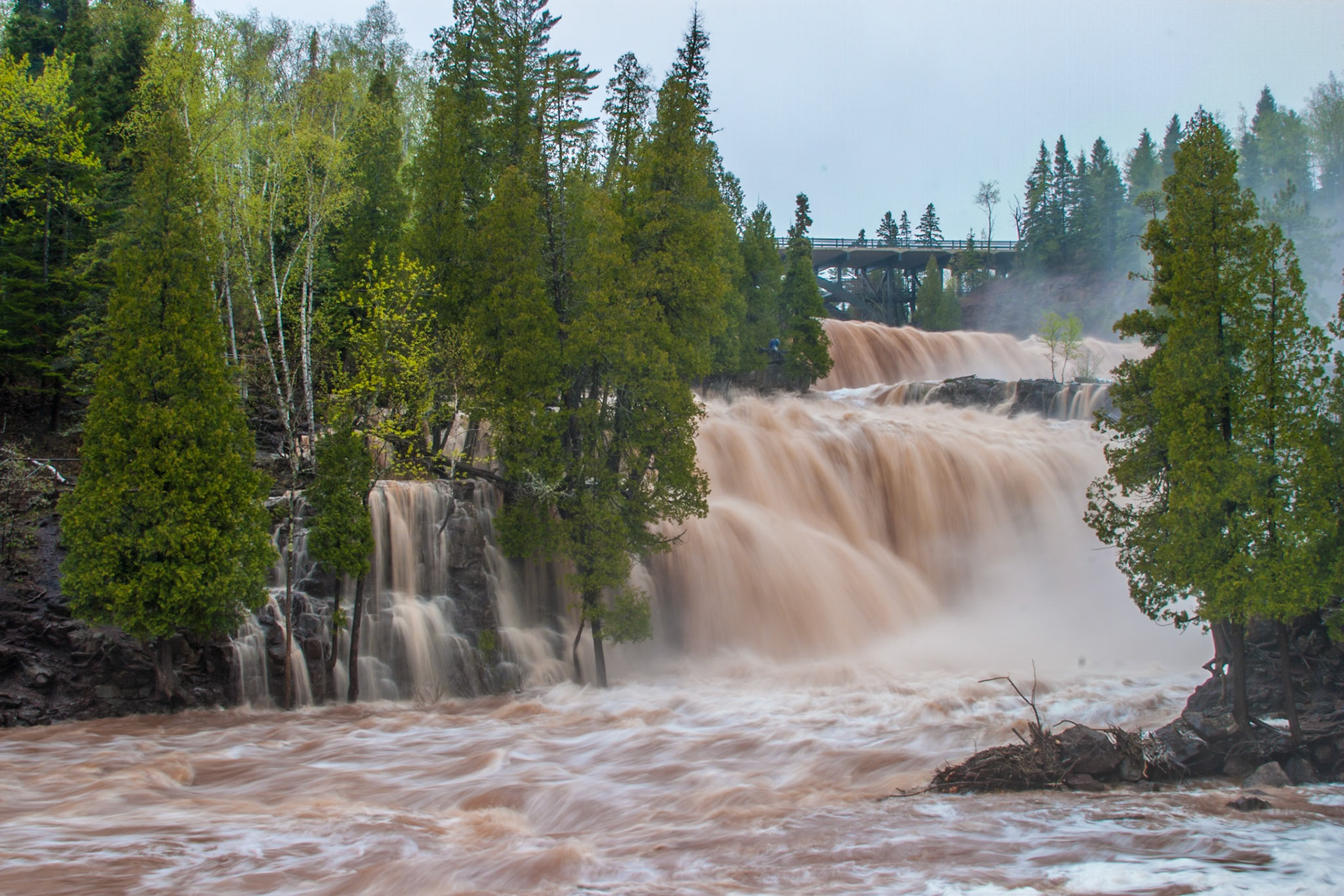 GoosebeMay 14 - Spring Runoff at Gooseberry FallsWhen heavy spring rains combine with meltwater from the inland swamps and bogs along the Northshore, the incredible power of falling water can be seen and felt.Whoever believes in me, as the Scripture has said, ‘Out of his heart will flow rivers of living water.’” John 7:38The hand of God is seen everywhere you look in nature.rry Falls
