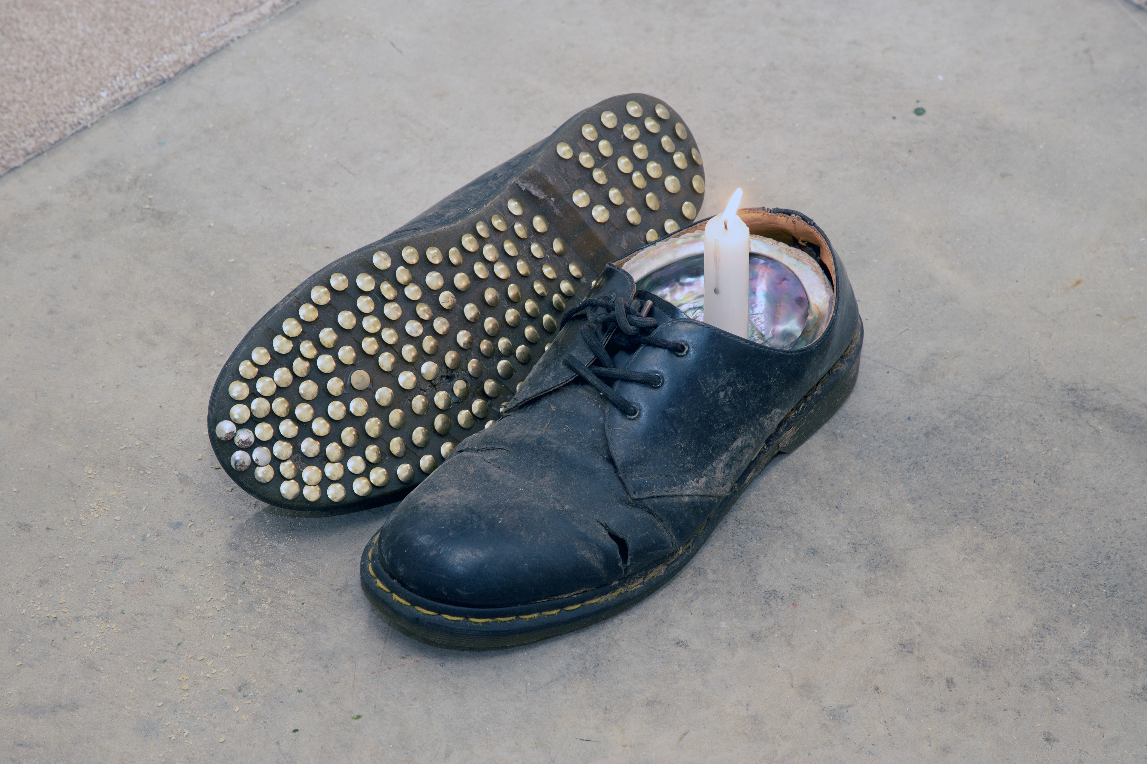 'The Devil in his Youth' (2026) Artists shoes, Shell, Candle, Tacks.