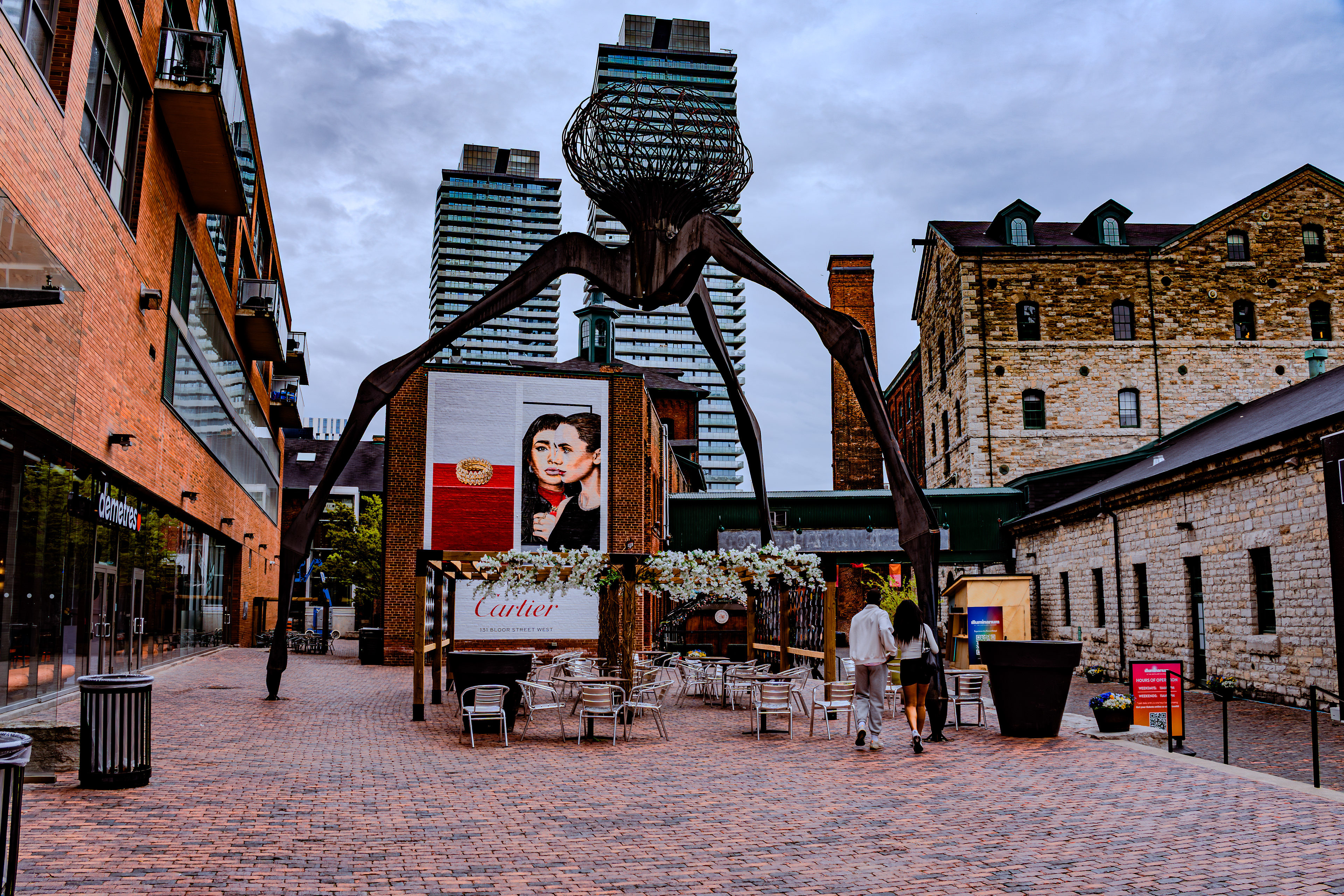 View of the Distillery District featuring a large outdoor sculpture and surrounding architecture.