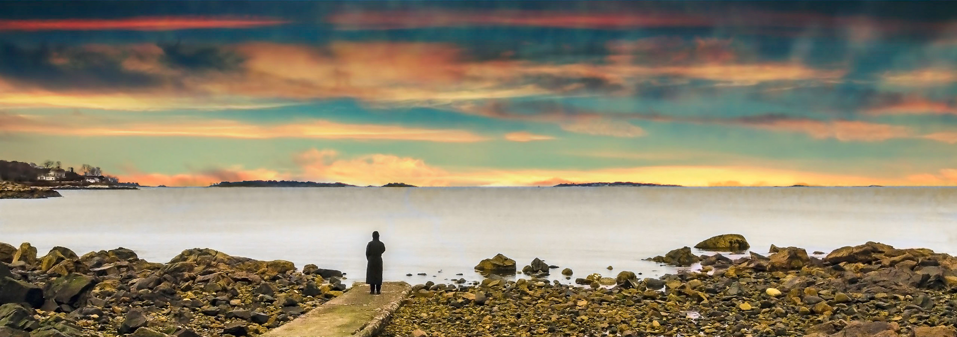 A person stands on the shore of Lynch Park and dreams of springtime