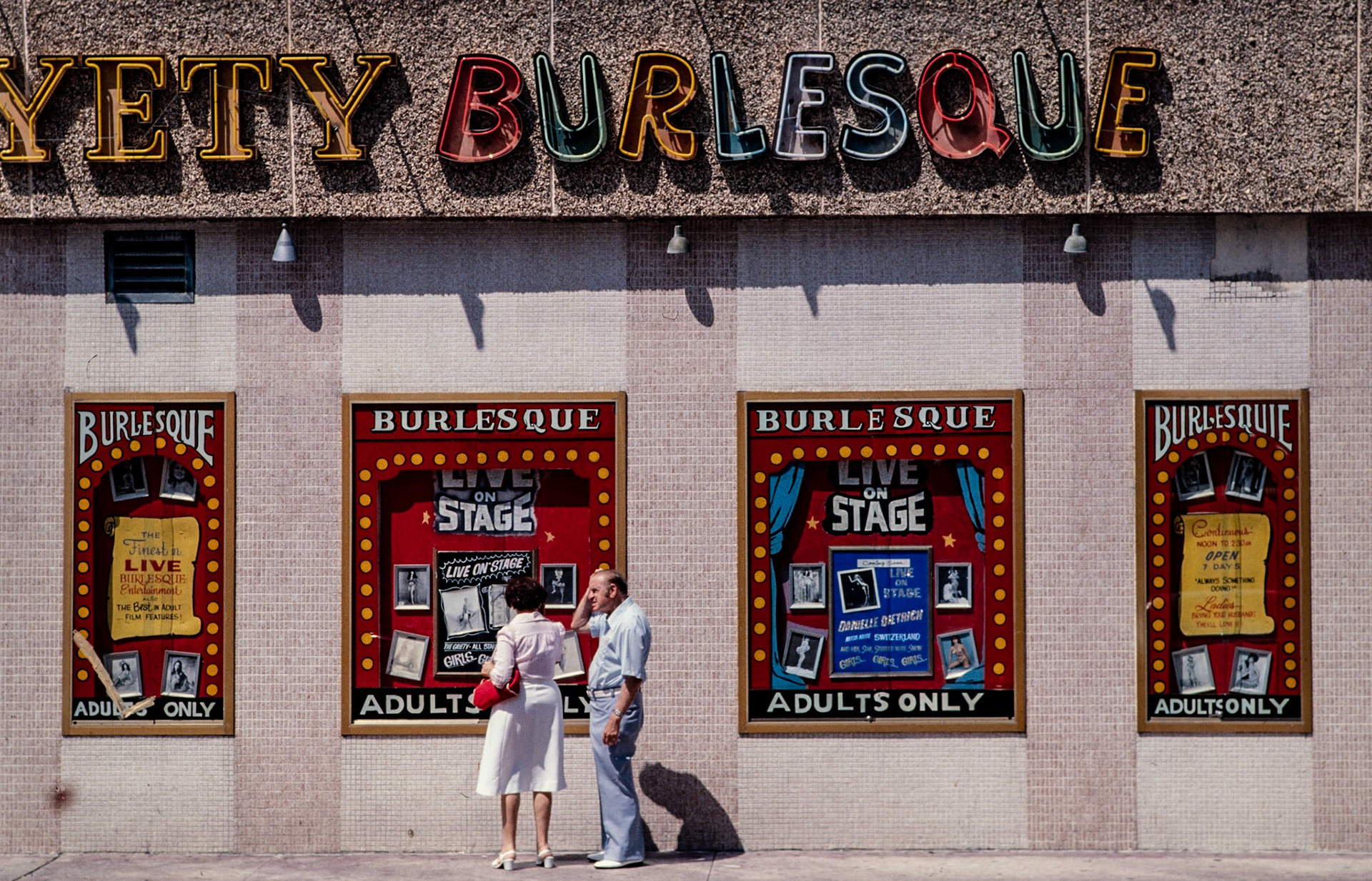 A couple stop to read about the performers in a burlesque theater in Miami
