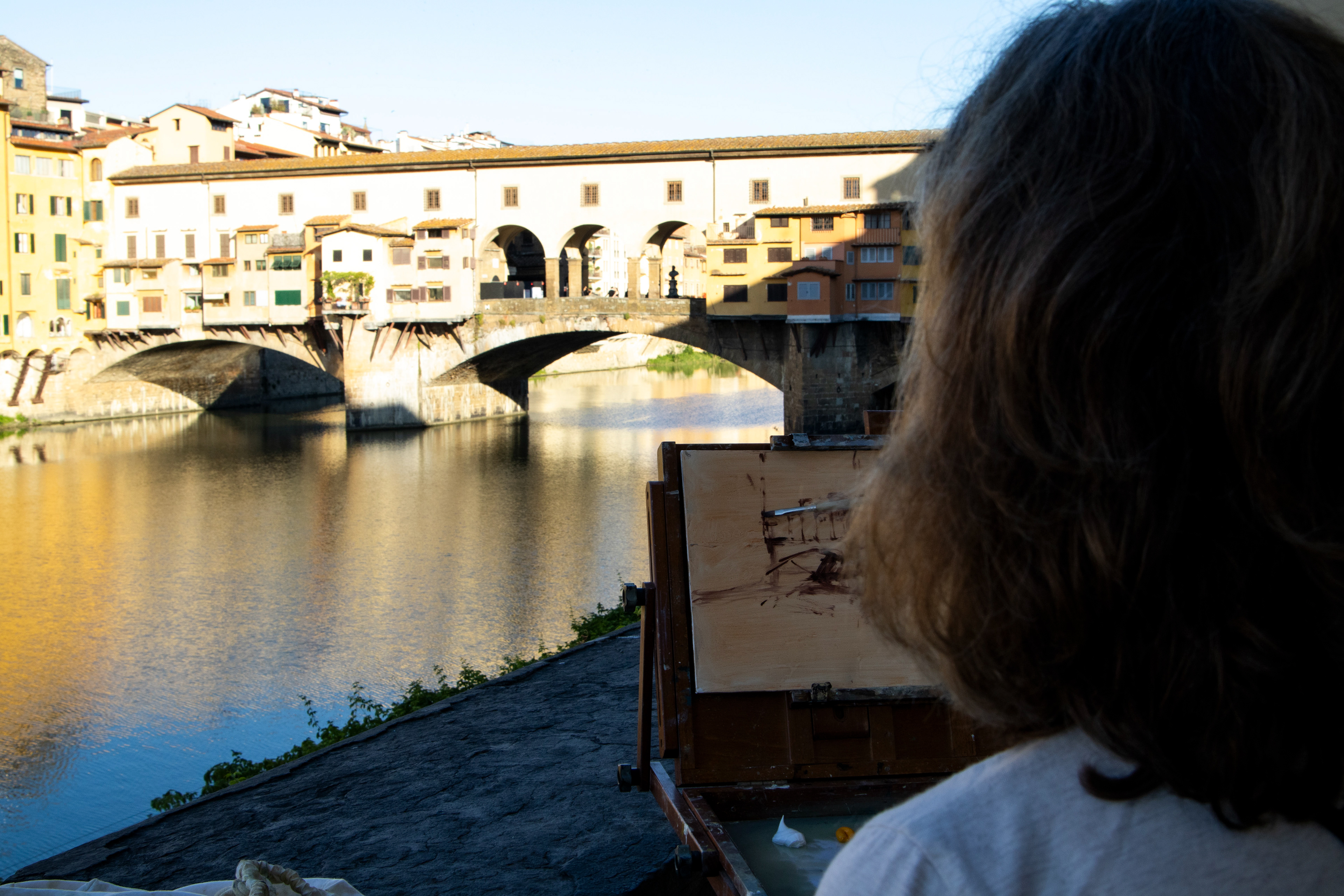 California Hartland college professor, Georgesse Gomez, sketches the “Ponte Vechio” bridge before adding the color in Florence, Italy on Saturday, May 31, 2025. 
