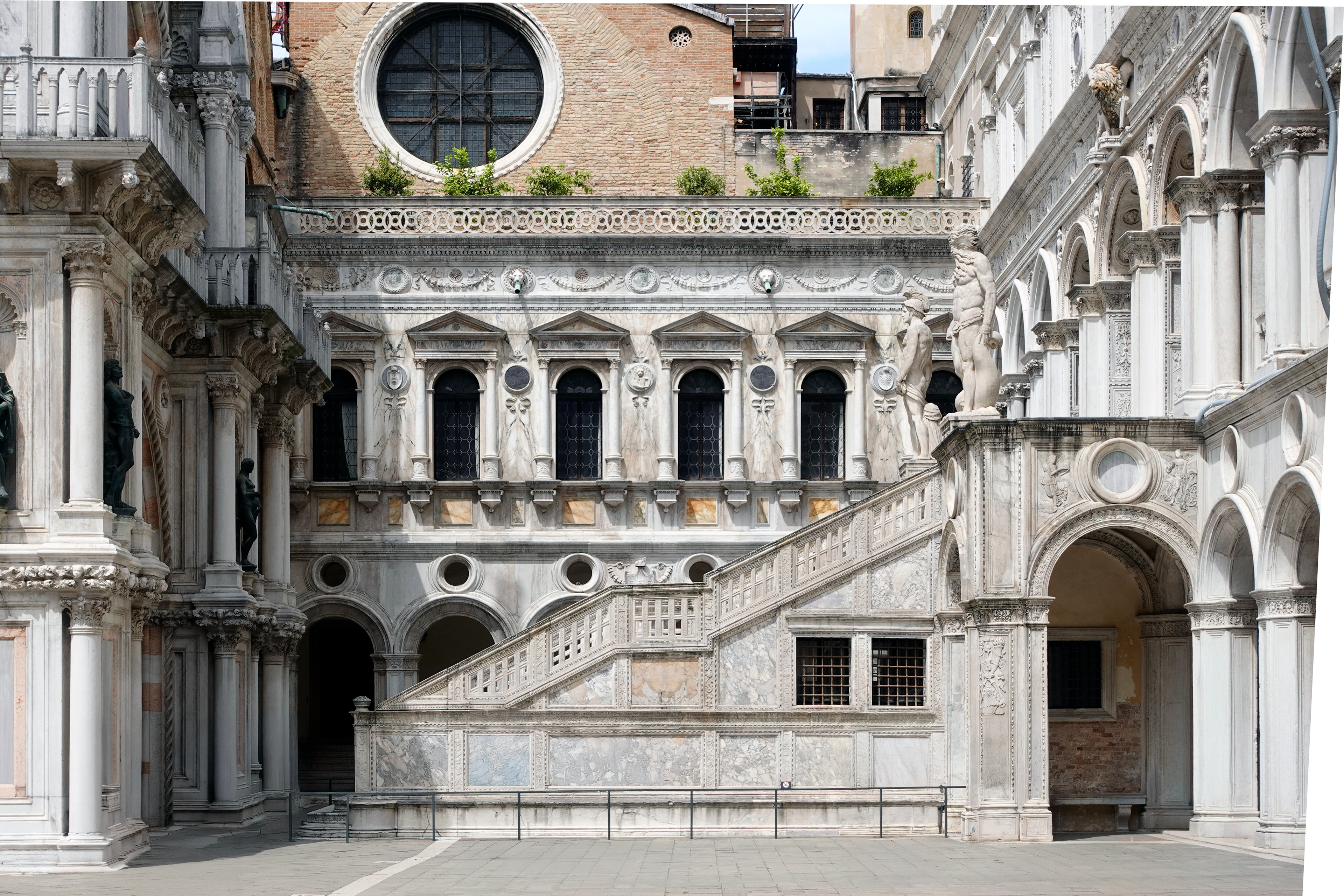 The grand marble staircase of the Doge Palace courtyard.