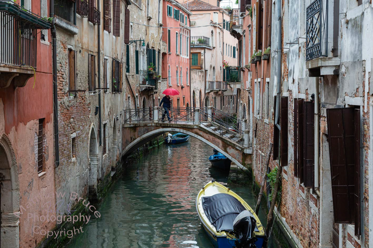 Crossing a canal in the rain