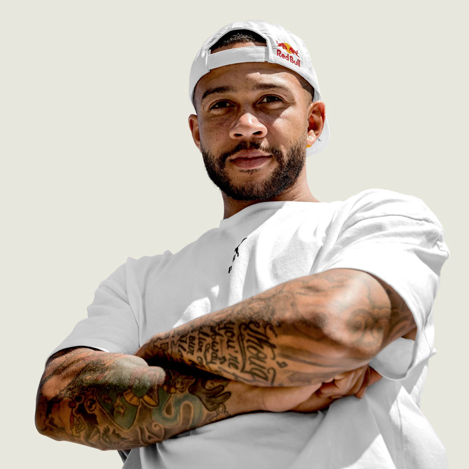 Memphis Depay with Red Bull cap, his arm crossed with visible arm tattoo's