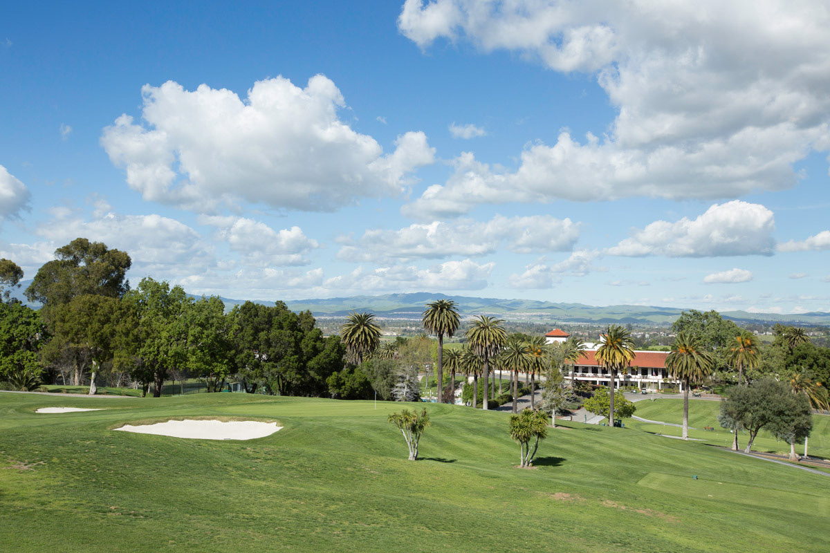 golf-course-sand-trap-with-puffy-clouds-in-bright-blue-sky
