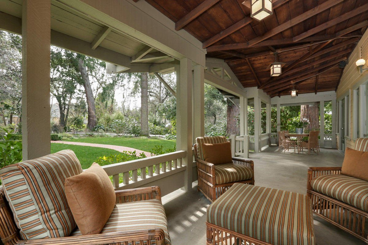 wide=covered-front-porch-with-seating-and-garden-setting