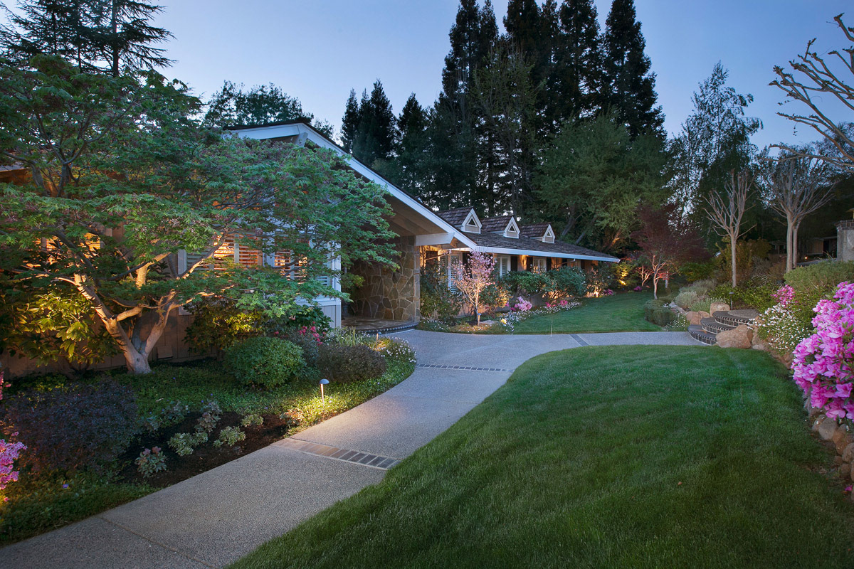 twilight-of-ranch-style-home-with-floral-gardens-and-redwood-trees