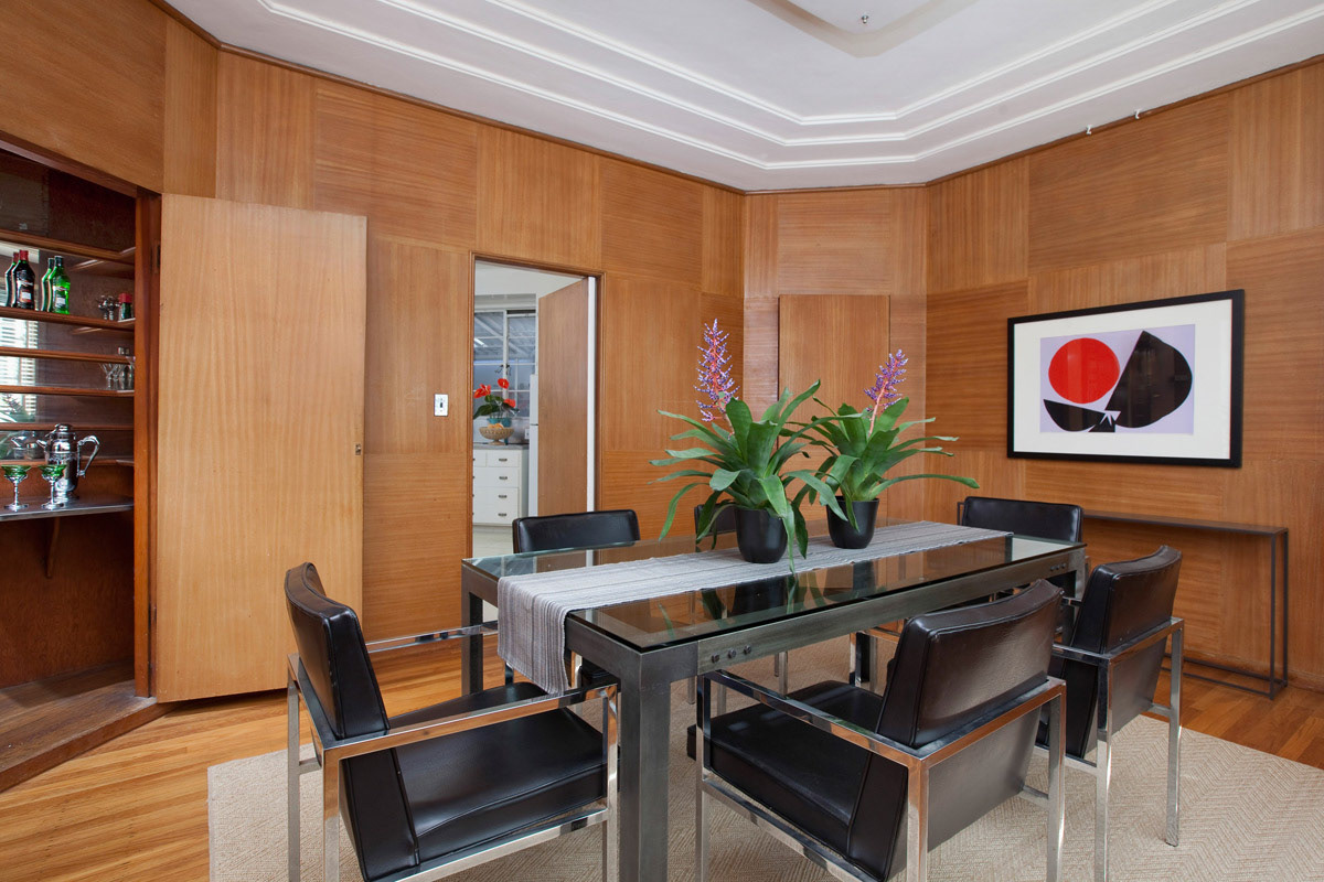 wood-paneled-art-deco-dining-room-with-built-in-hidden-bar