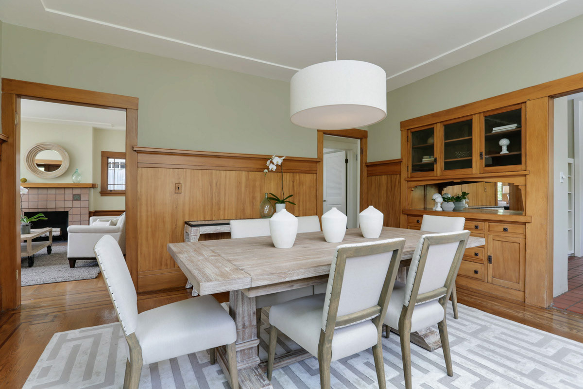 dining-room-table-six-grey-wood-beige-upholtered-chairs-cherry-woord-wainscothing-off-white-drum-shaded-light-fixture