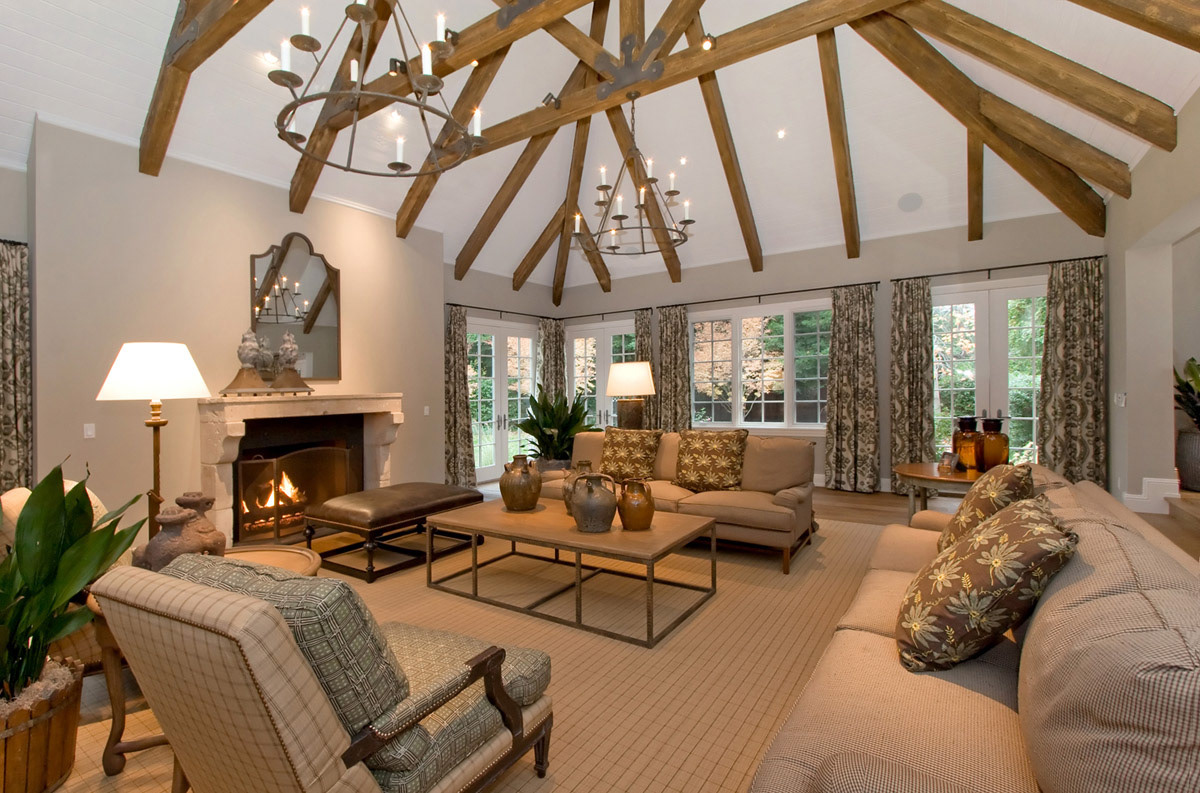 large-white-oak-beamed-ceiling-living-room-with-iron-chandeliers-and-fireplace