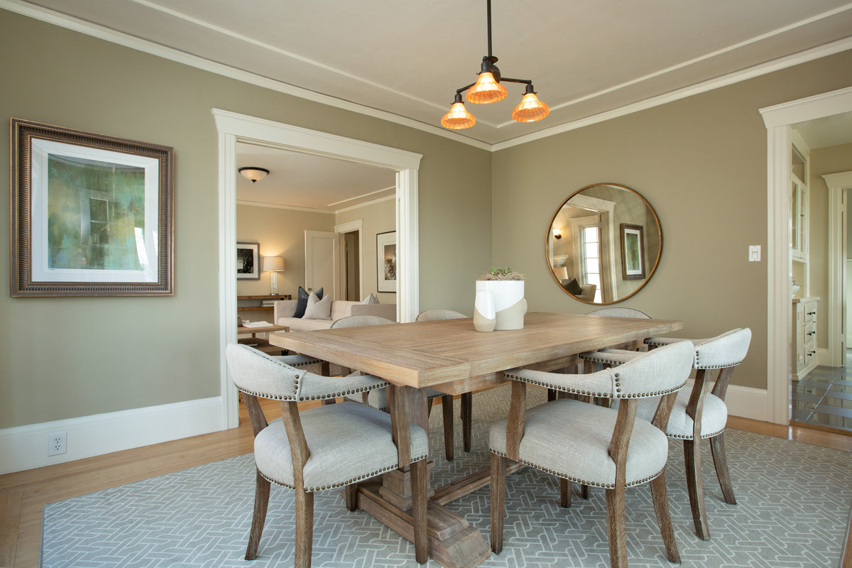 muted-green-dining-room-with light-woodtables-and-linen-upholstered-chairs