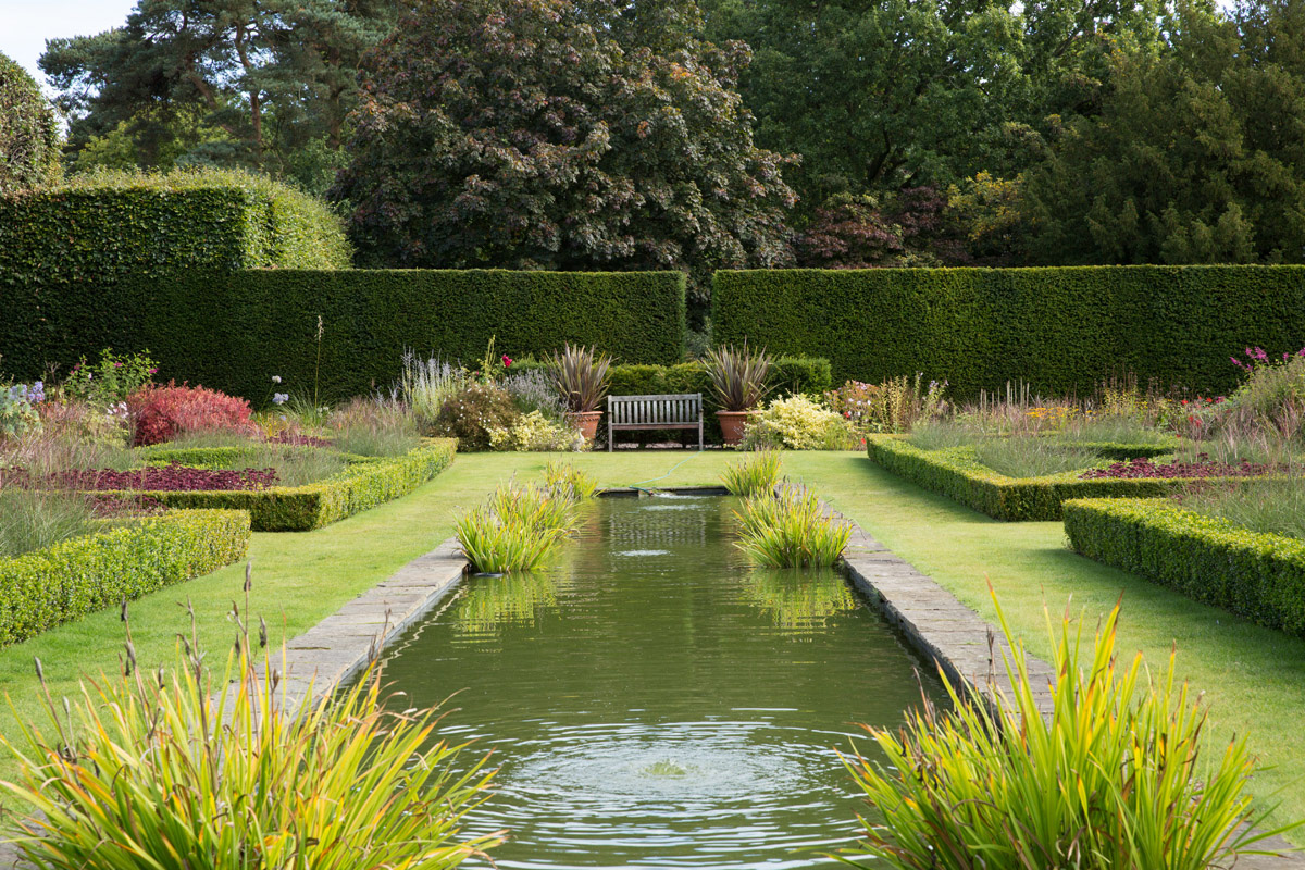 manicured-english-garden-bench-and-pond