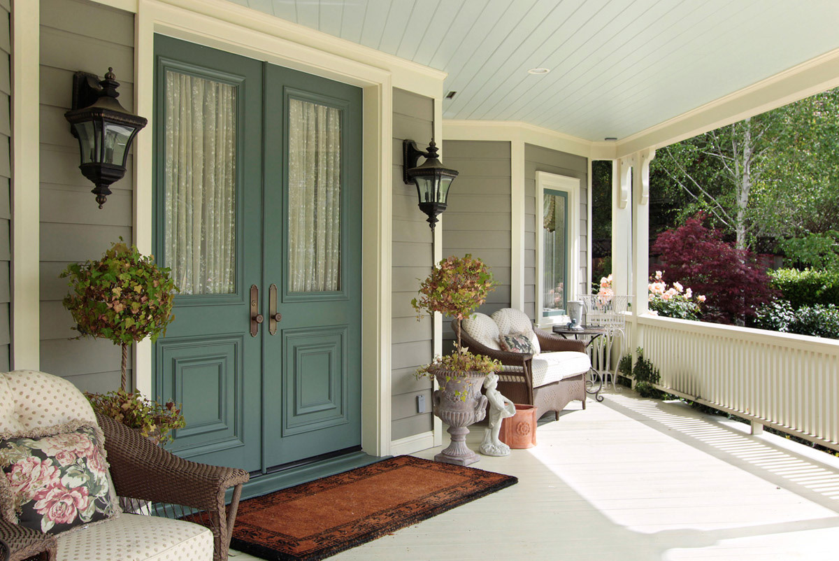 turquoise-double-front-doors-on-front-porch-withwicker-seating-and-potted-topiary
