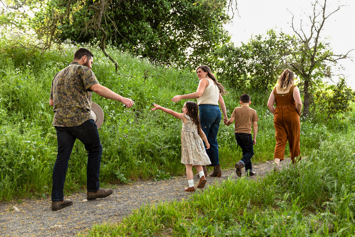family-of-five-walk-up-park-trail