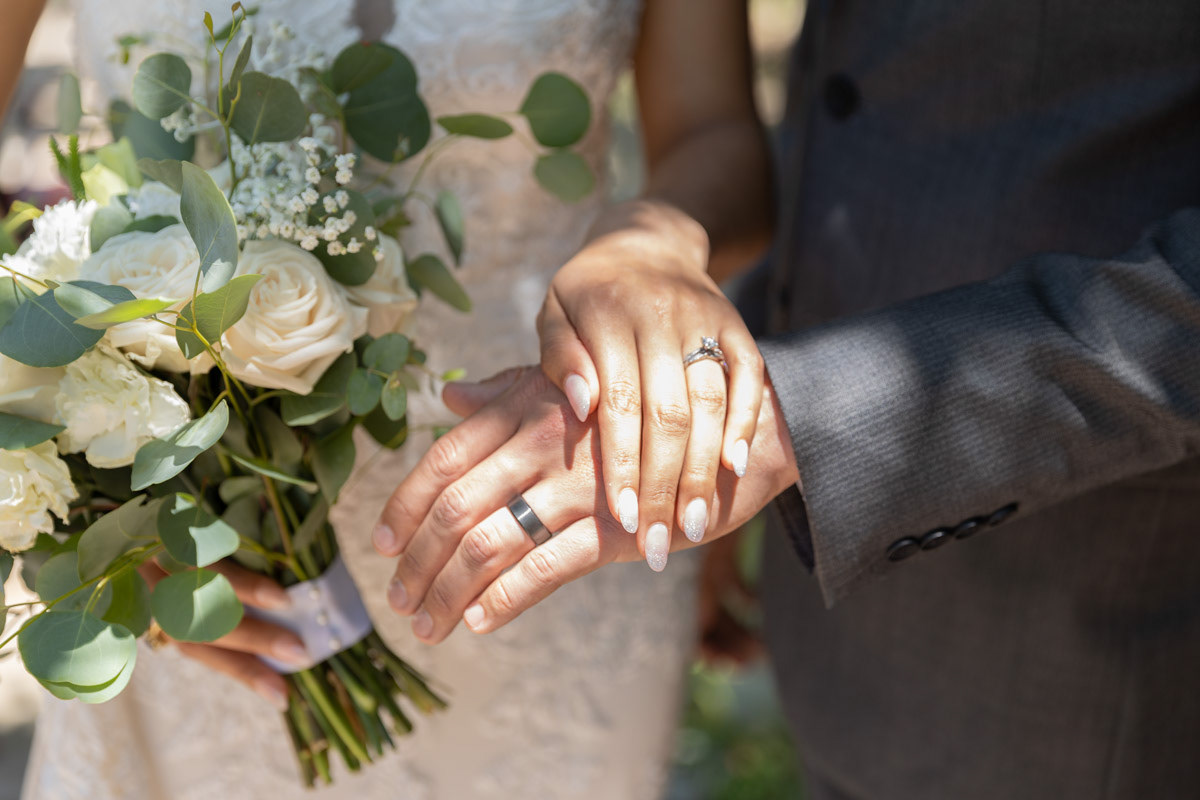 bride-with-ringed-hand-over-grooms-ringed-hand