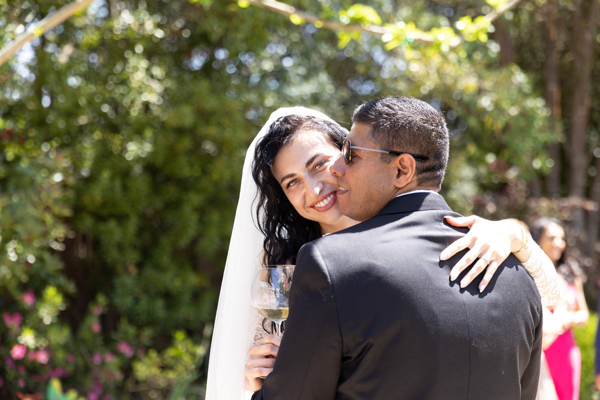 bride-and-groom-embrace-in-garden