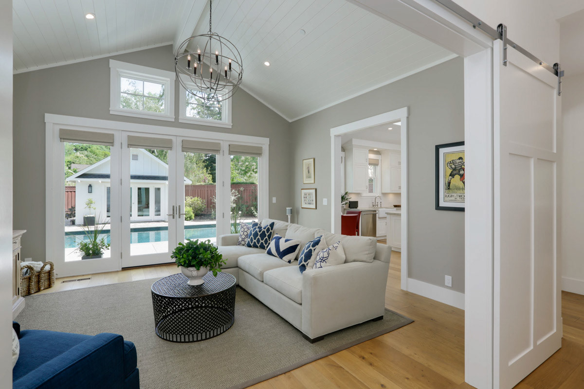 livingroom-with-pool-view-orb-chandelier-and-barn-door