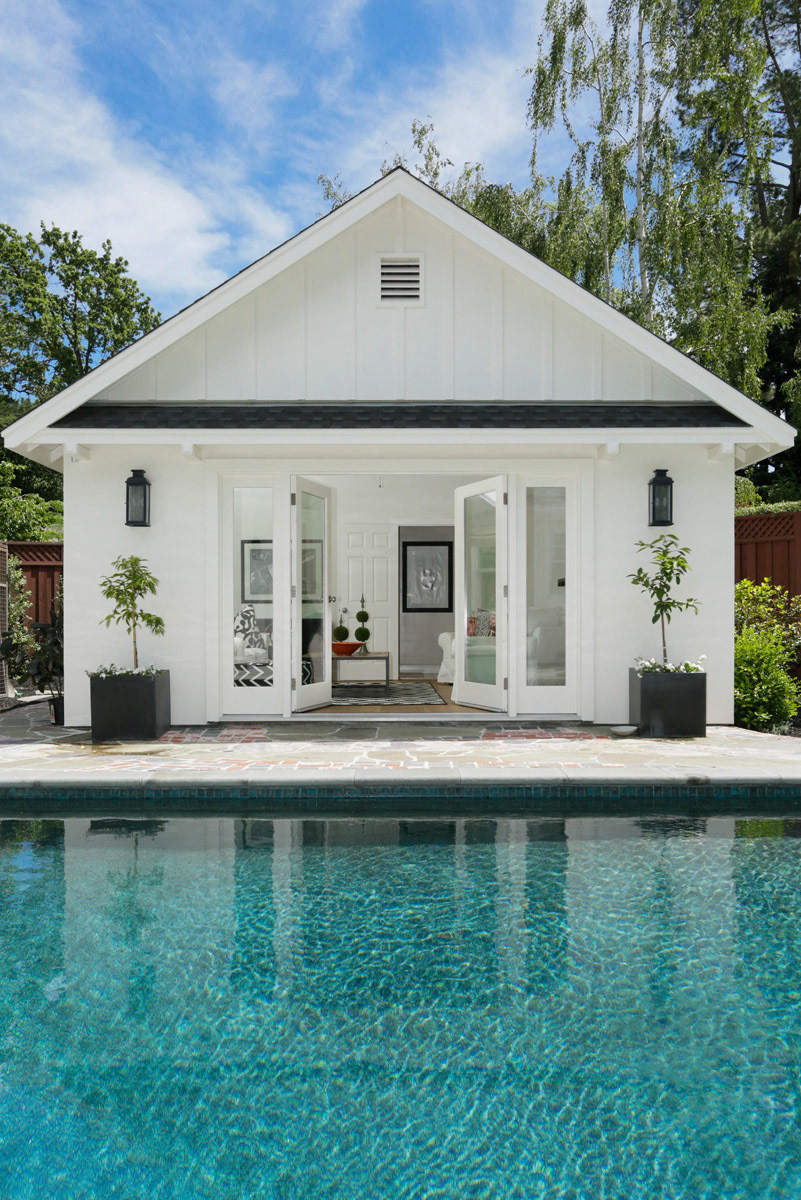 White-pool-house-with-open-French-doors