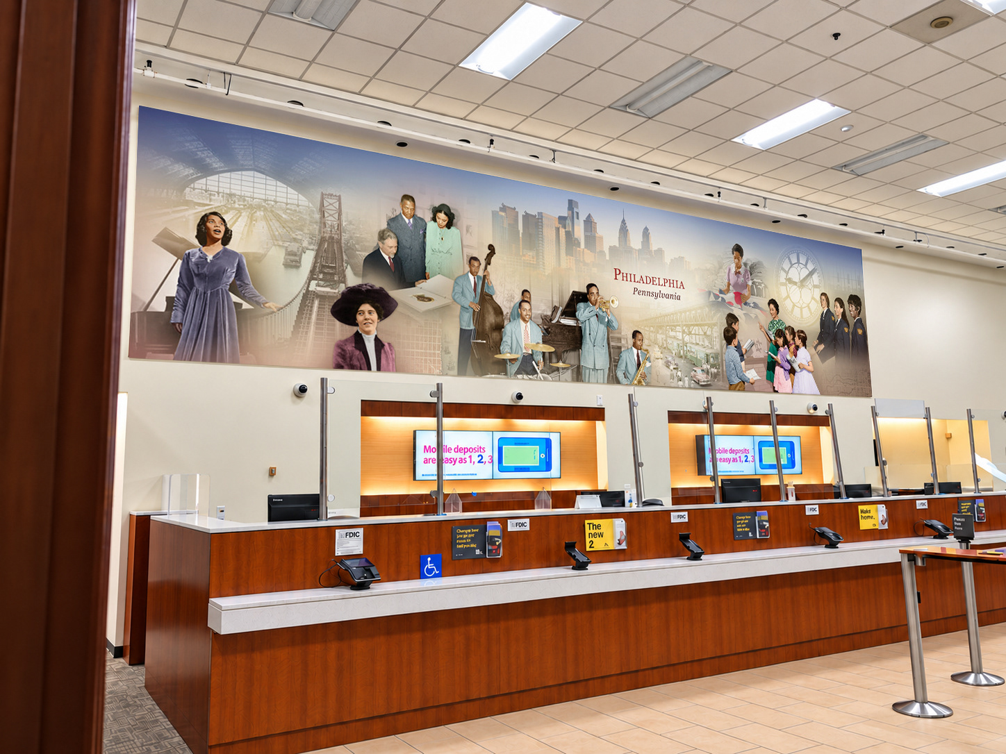Printed Market Street Philadelphia community mural installed above the bank service counter, before its adaptation into a pan-through digital Spotlight.