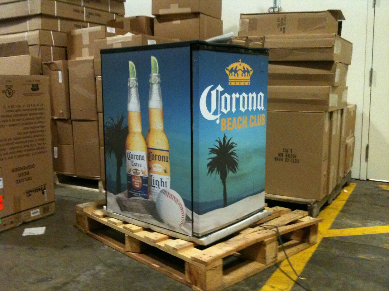 Completed Corona Beach Club refrigerator wrap on a pallet, with beverage bottles, baseball imagery, and beach graphics applied across the front and side.