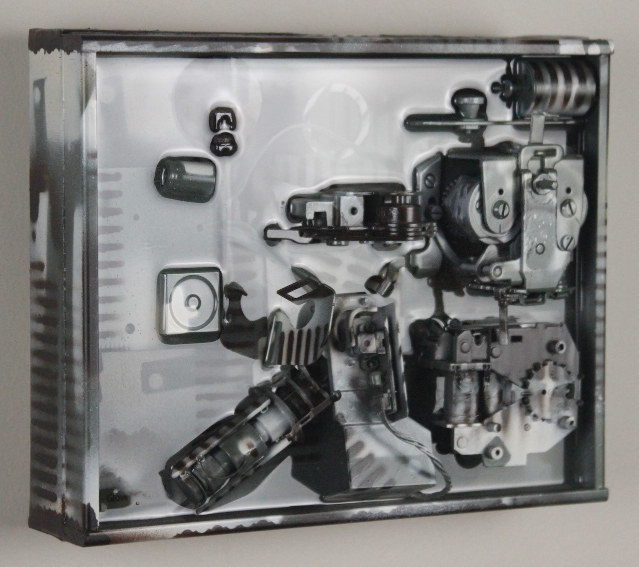 Kit; $520 (H:8” x W:10” x D:3.5”) Assorted machine parts, spray paint, epoxy resin, canvas covered wood base