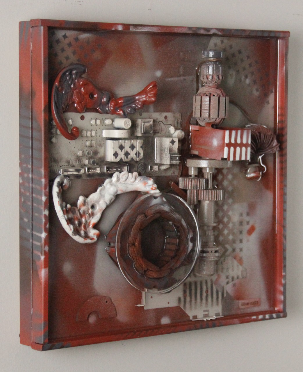 It spreads its wings to catch them and carries them off.; $990 (H:12” x W:12” x D:3.5”) Decorative lamp parts, machine parts, computer circuits, hand drill innards, spray paint, epoxy resin, wood base