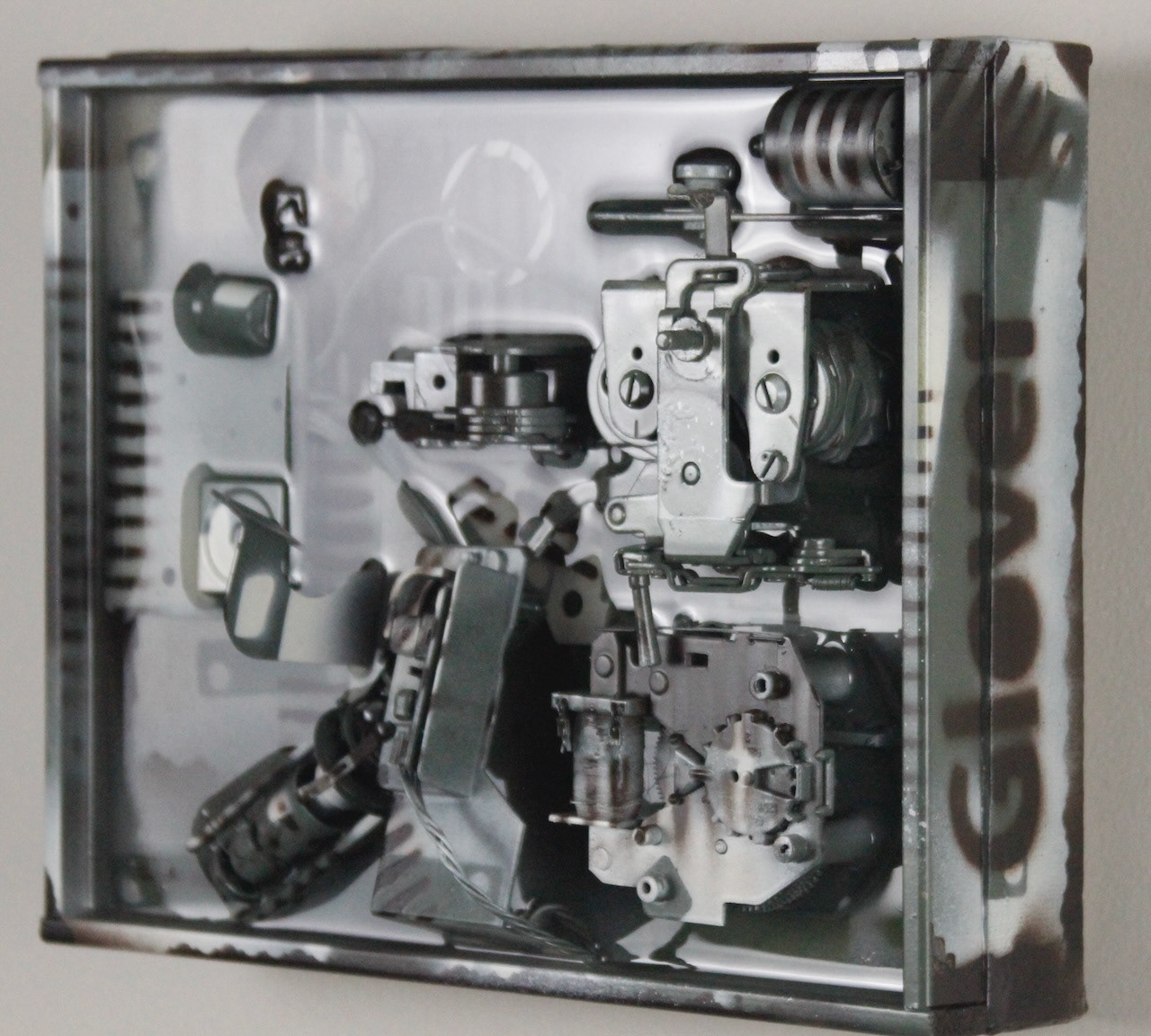 Kit; $520 (H:8” x W:10” x D:3.5”) Assorted machine parts, spray paint, epoxy resin, canvas covered wood base