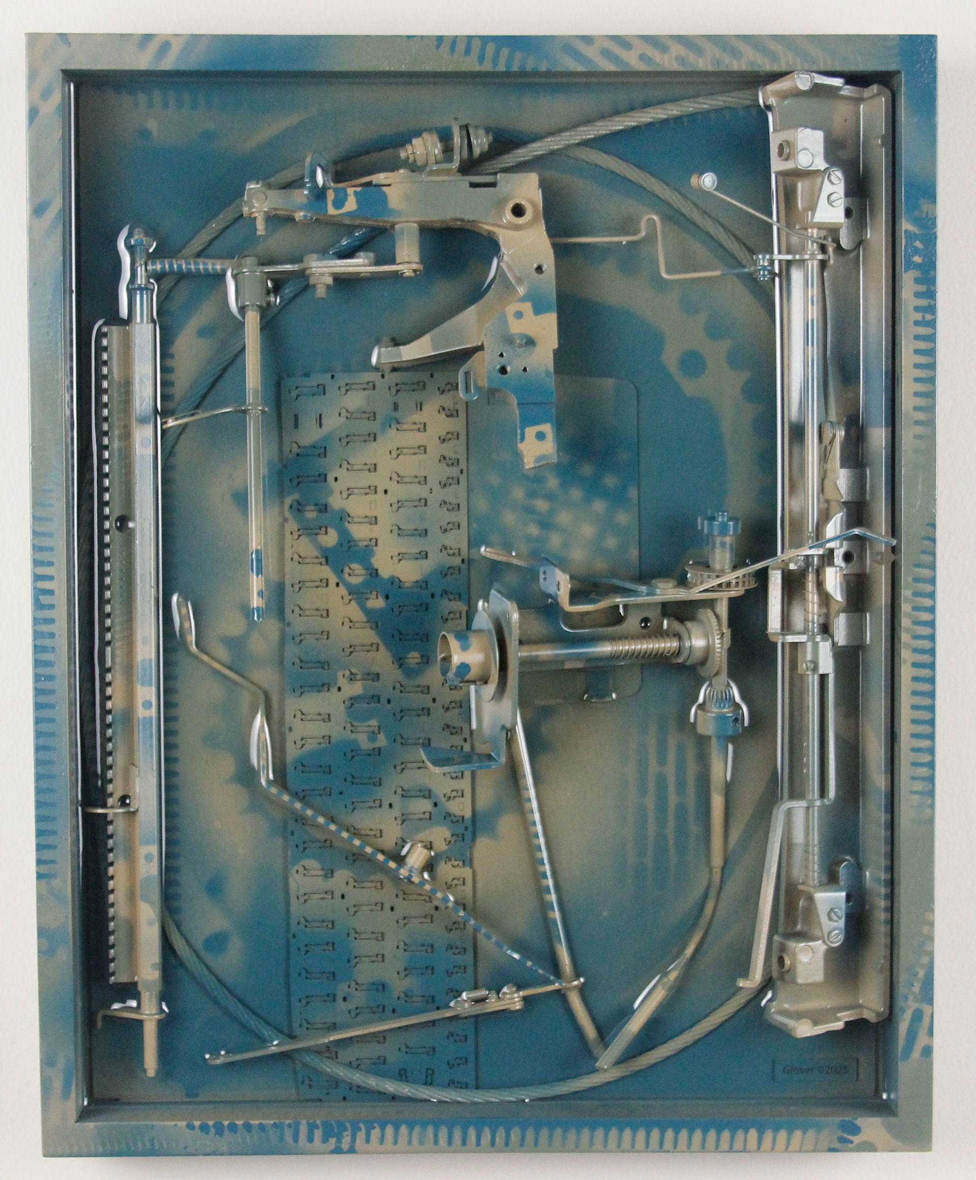 Concinnity; $1300 (H:16.375” x W:12.3125” x D:3.25”) Steel cable, underside of partial laptop keyboard, typewriter parts, spray paint, epoxy resin, wood backing