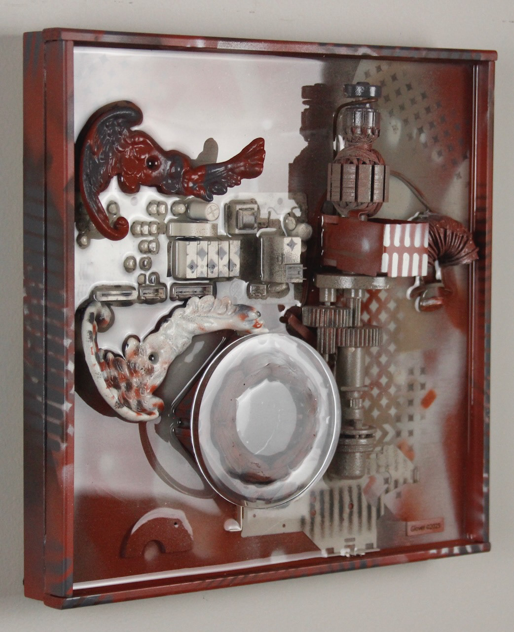 It spreads its wings to catch them and carries them off.; $990 (H:12” x W:12” x D:3.5”) Decorative lamp parts, machine parts, computer circuits, hand drill innards, spray paint, epoxy resin, wood base