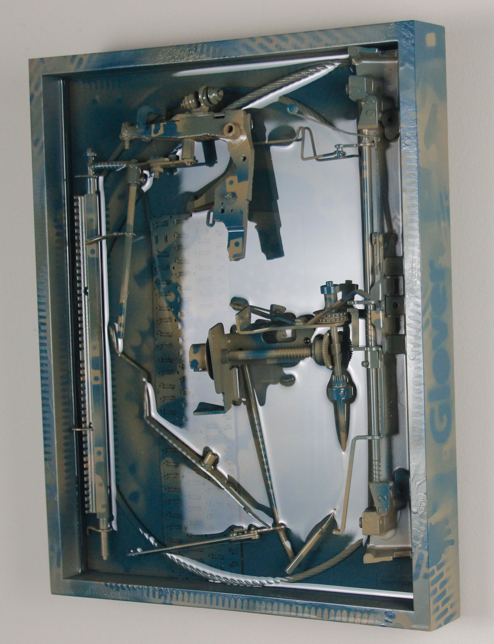 Concinnity; $1300 (H:16.375” x W:12.3125” x D:3.25”) Steel cable, underside of partial laptop keyboard, typewriter parts, spray paint, epoxy resin, wood backing