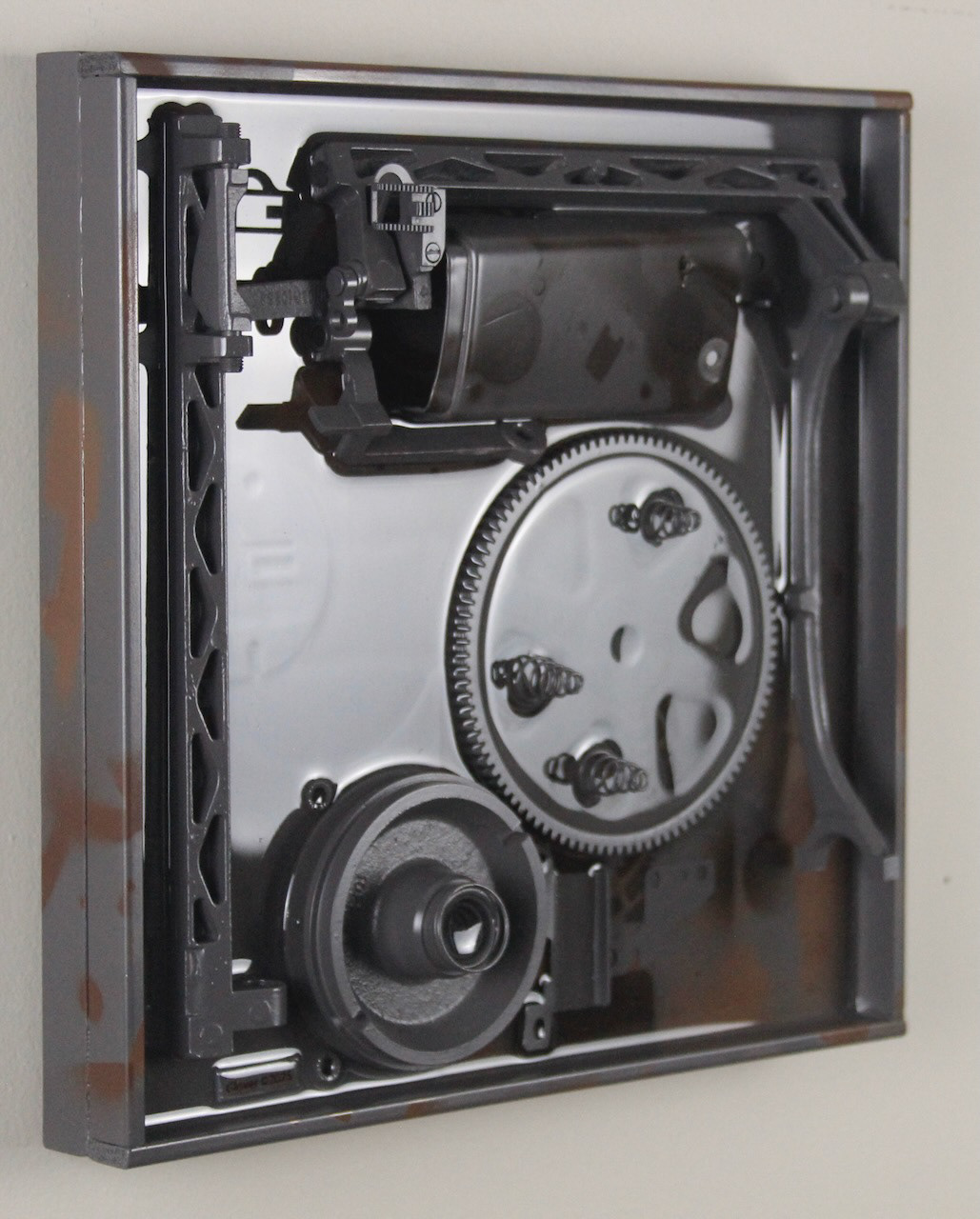 Deep Springs Below; $940 (H:12” x W:12” x D:2.75”) Assorted machine parts, spray paint, epoxy resin, wood base