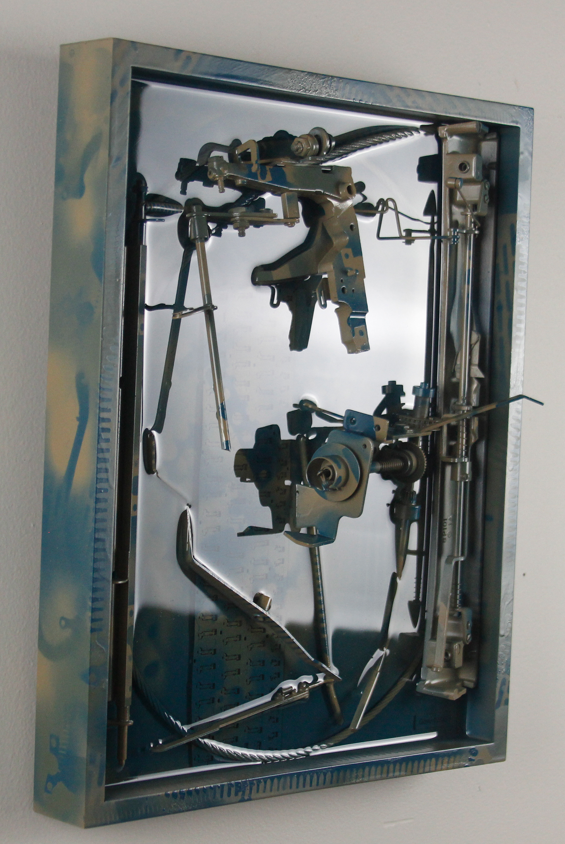 Concinnity; $1300 (H:16.375” x W:12.3125” x D:3.25”) Steel cable, underside of partial laptop keyboard, typewriter parts, spray paint, epoxy resin, wood backing