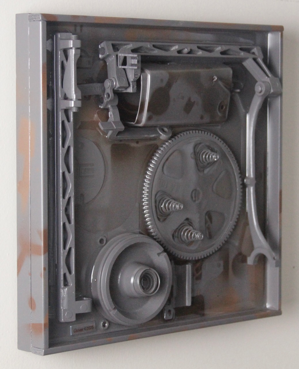 Deep Springs Below; $940 (H:12” x W:12” x D:2.75”) Assorted machine parts, spray paint, epoxy resin, wood base