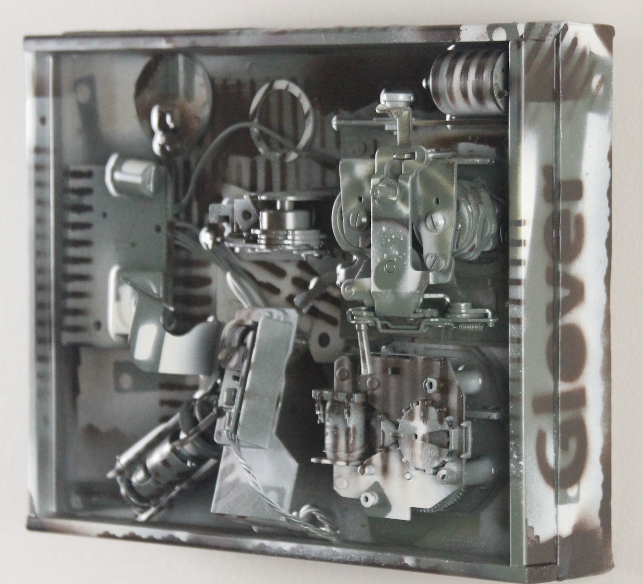 Kit; $520 (H:8” x W:10” x D:3.5”) Assorted machine parts, spray paint, epoxy resin, canvas covered wood base