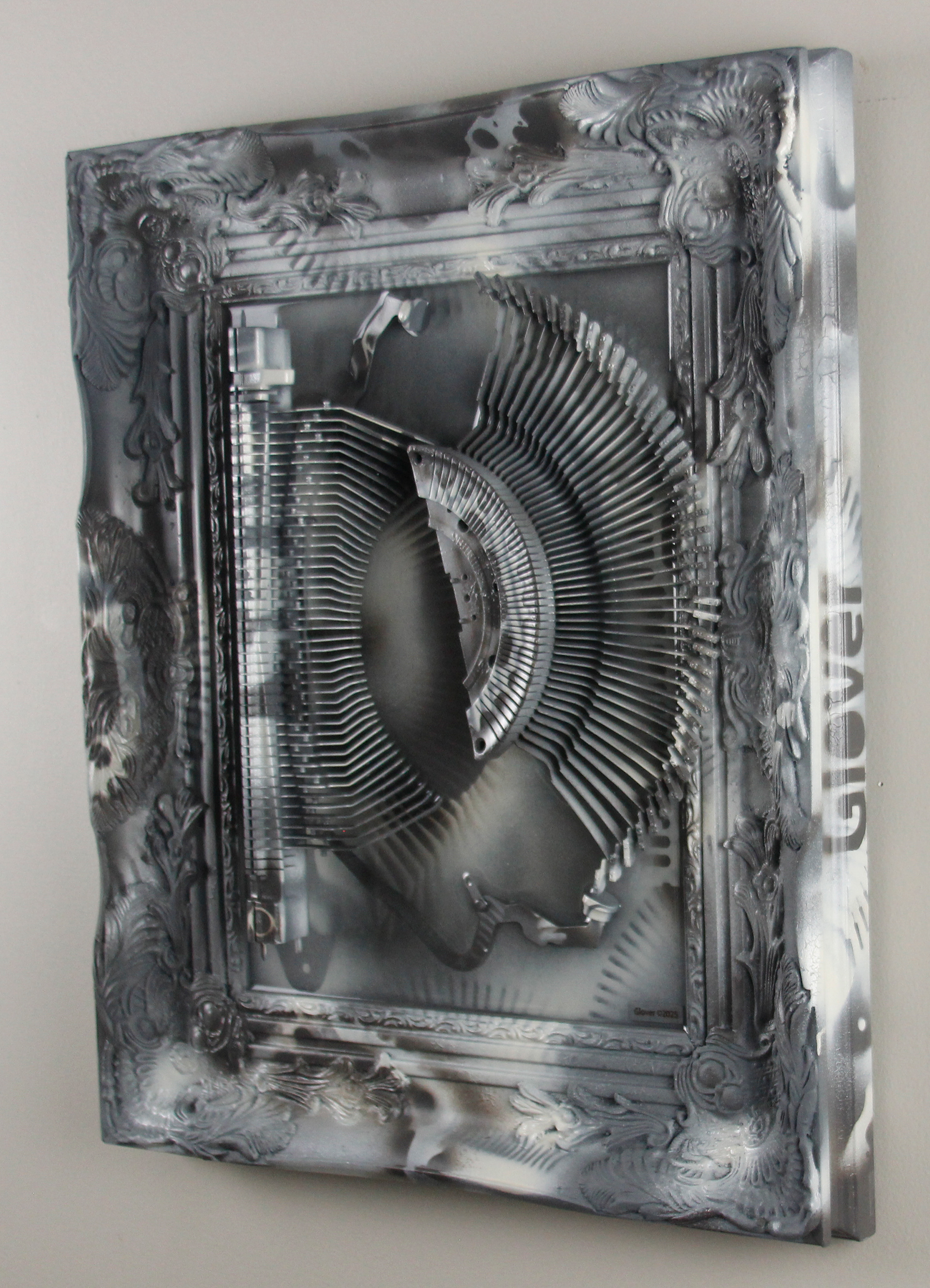 Shifting Satiation; $2200 (H:20” x W:17” x D:2.5”) Typewriter parts, spray paint, epoxy resin, wood base 