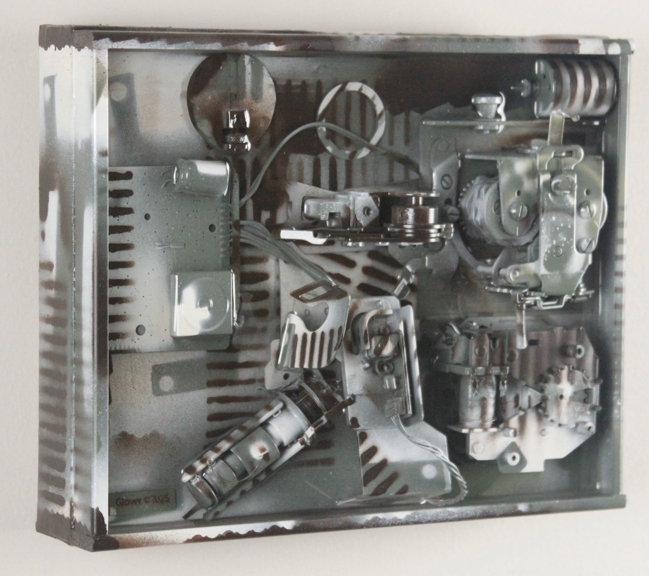 Kit; $520 (H:8” x W:10” x D:3.5”) Assorted machine parts, spray paint, epoxy resin, canvas covered wood base