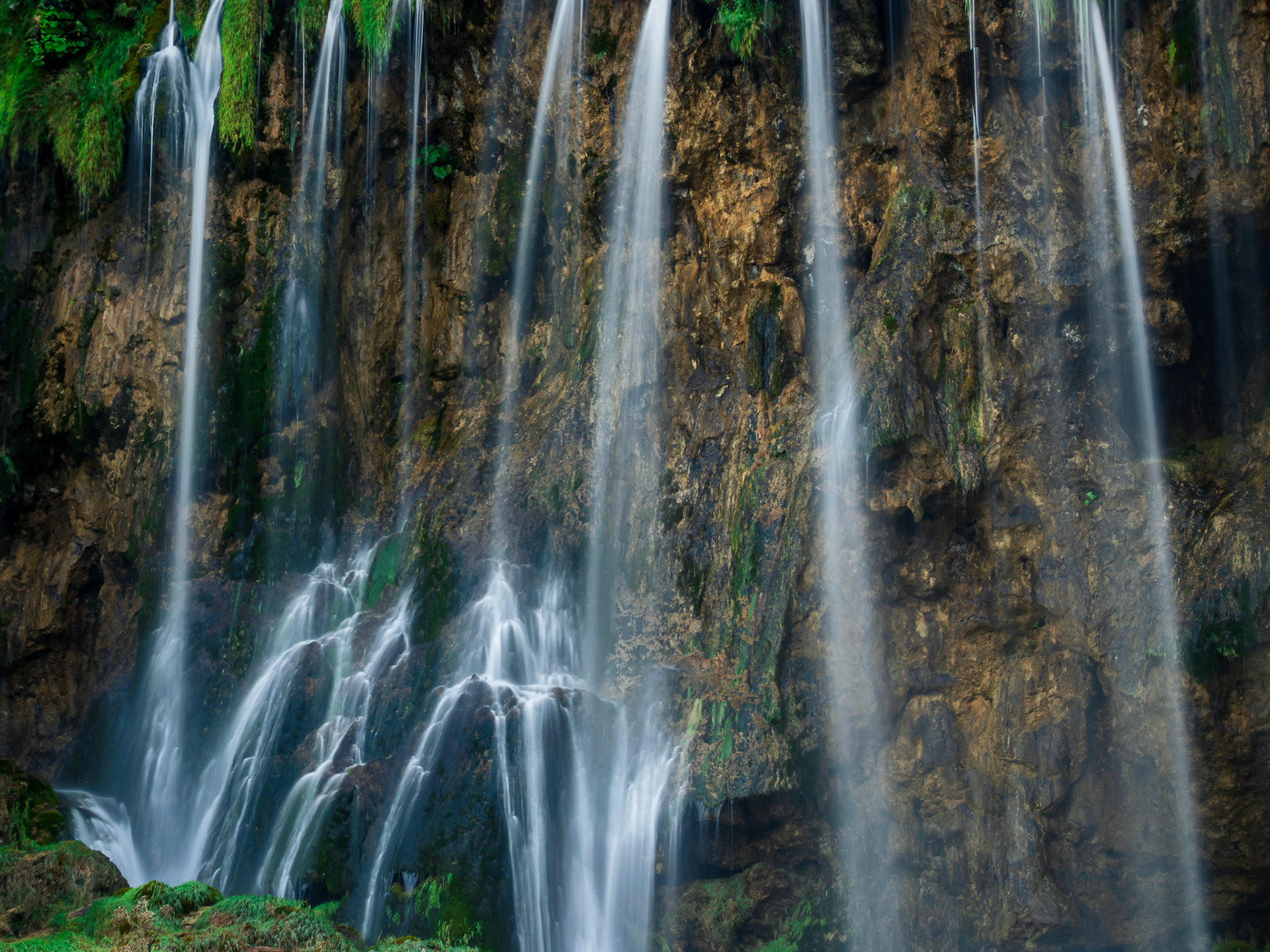 Graceful waterfalls descend like soft chords in a hidden amphitheater.