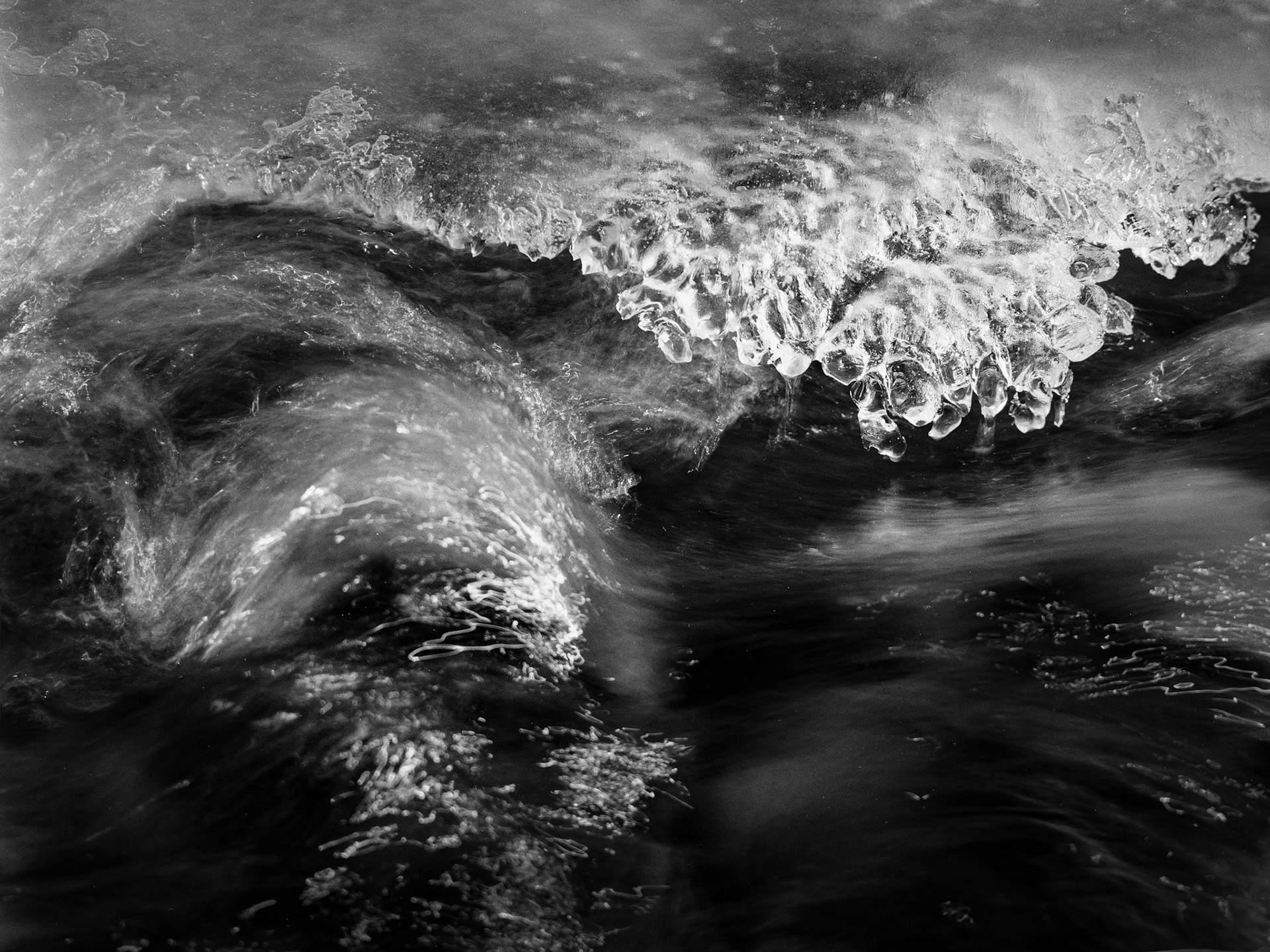 Fringe ice meets moving water on the Poudre River.