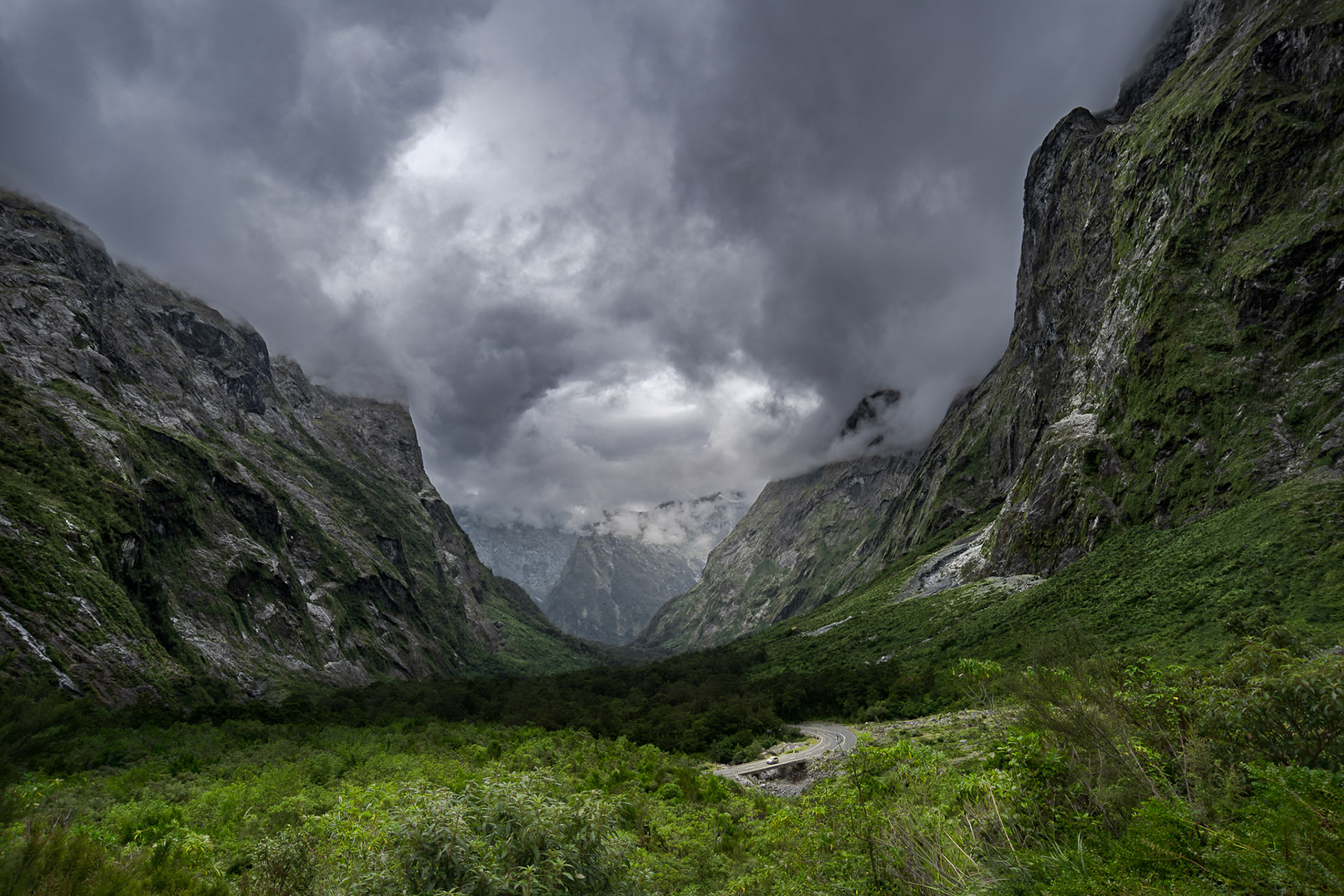 Low clouds curn over vertical granite walls on a stormy afternoon.