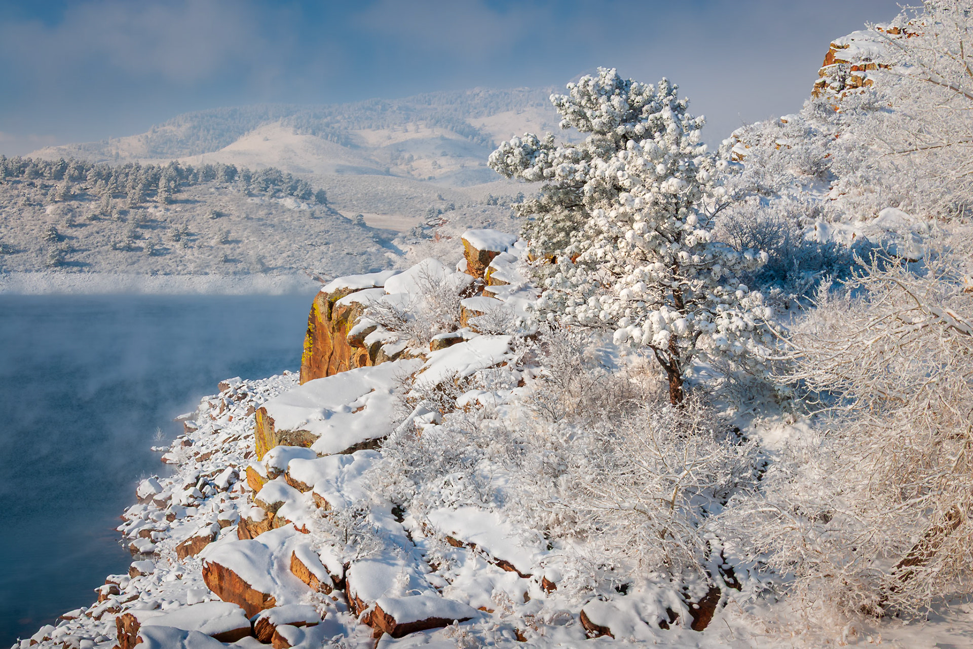 Lake, light, and snow converge in serene geometry.