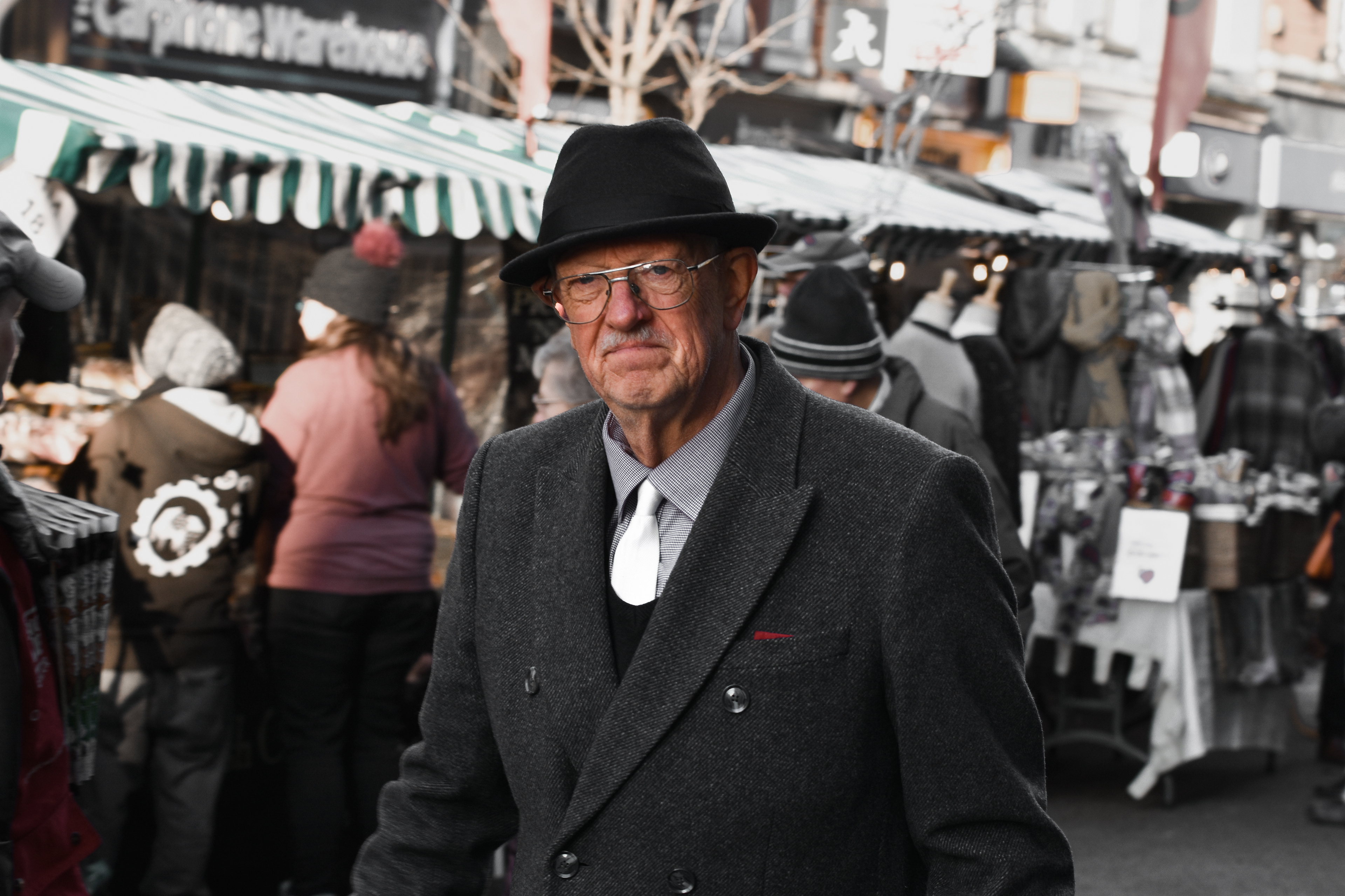 Street Photography in West Midlands. This portrait of an old, grumpy man was taken during the Christmas time in Worcester Christmas market. This photo is like a reminder to the film Christmas Carol