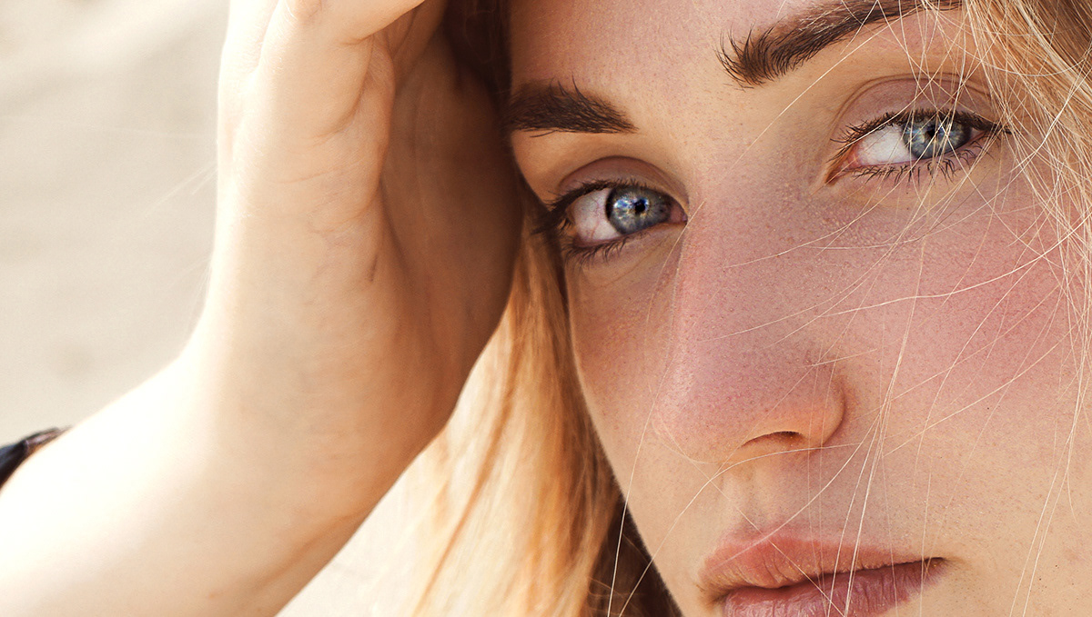 close up portrait photography. Blond girl model poses in front of the camera during the summer photoshoot. Blue eyes and glimpse captures in the close up portrait photography by woman photographer artbyrad
