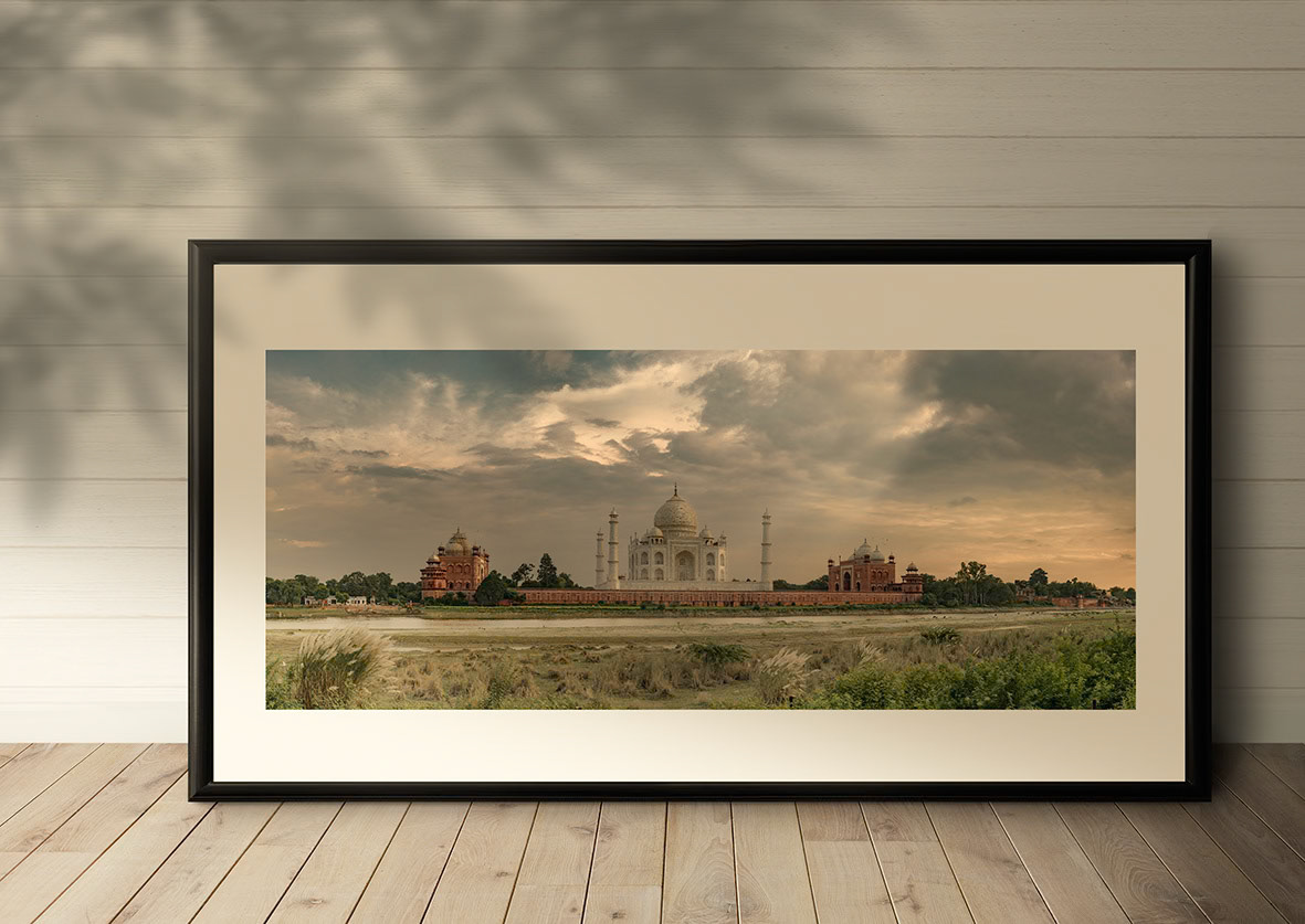 Black picture frame mockup on a wooden floor