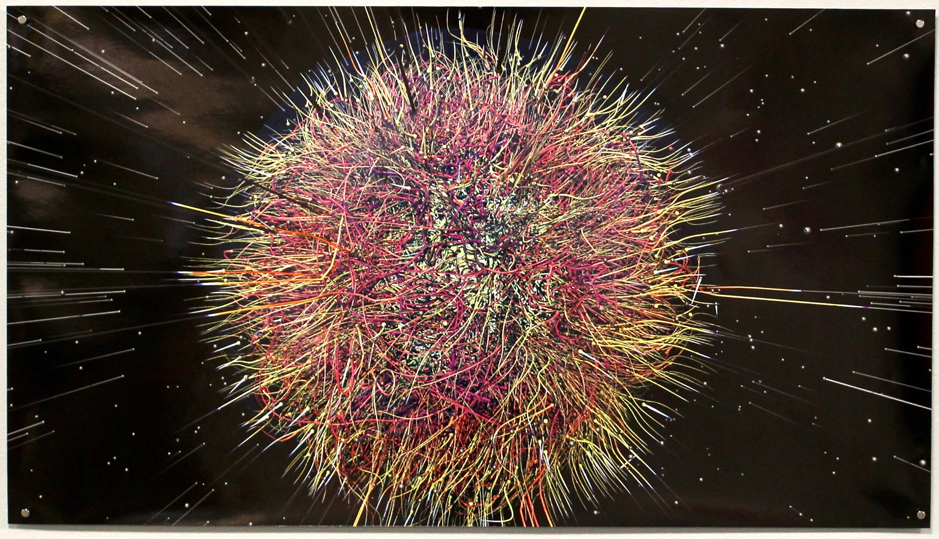 Data visualization of a Core-Collapse Supernova Explosion. Red, pink, peach, and yellow colored stringy orb centrally located on a black background with stars and streaks of light.