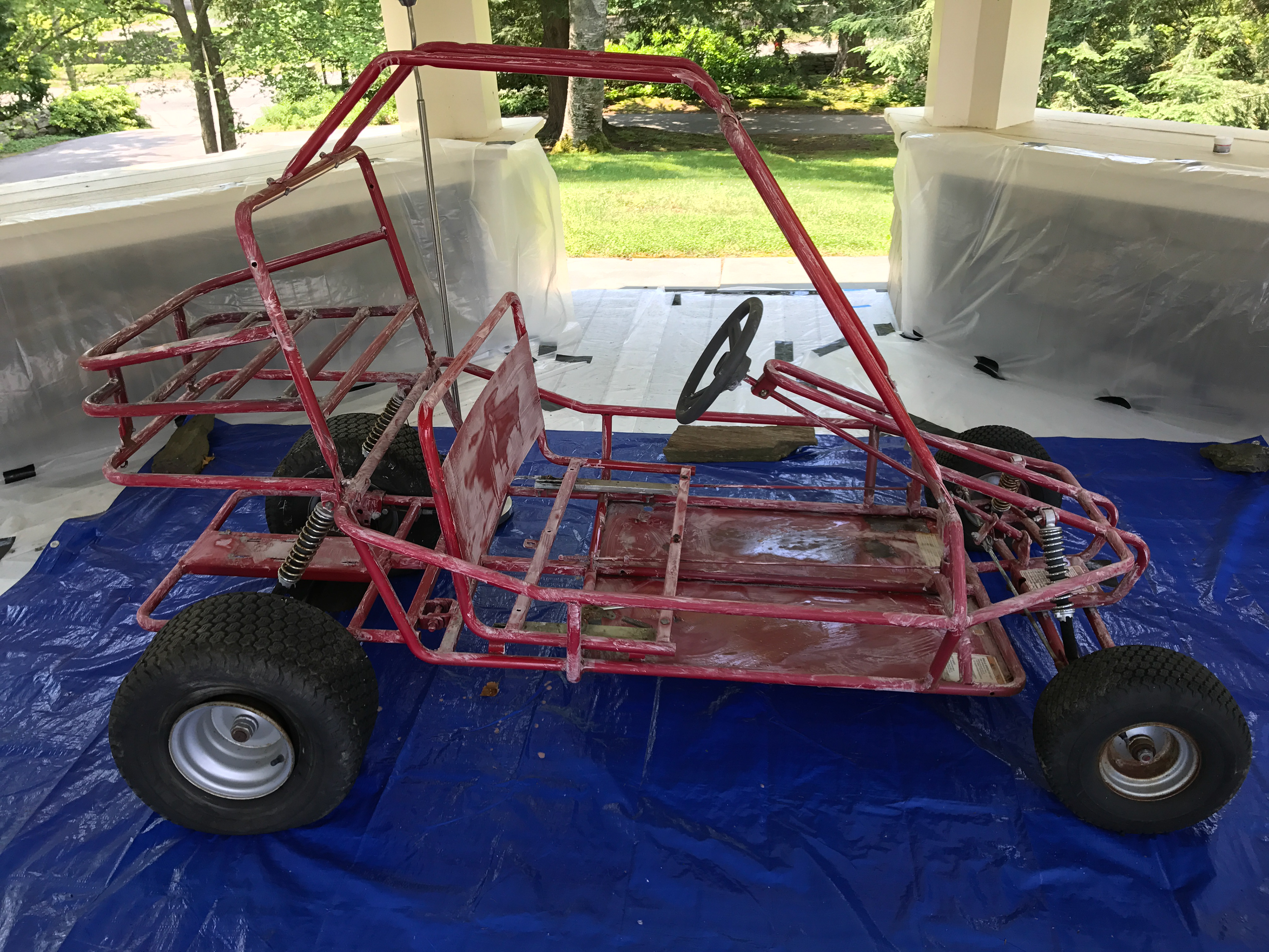 The go-kart I started with: it had been left outside for years. The frame had split in multiple places, the paint was flaking off, both rear tyres had come off their beads and the steering was badly out of alignment.