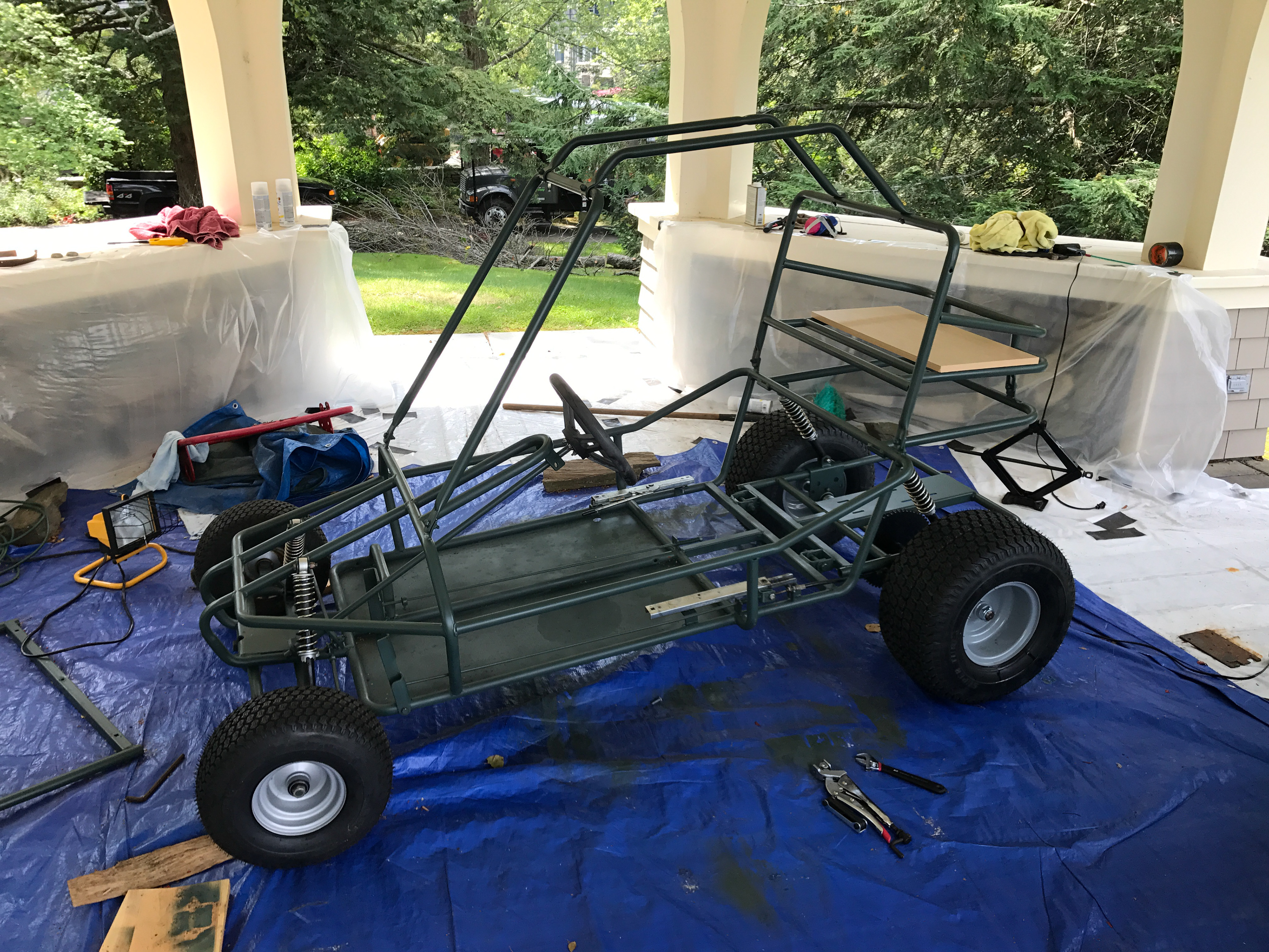 My first round of repairs: re-welded the split parts of the frame, stripped and repainted frame green, replaced rear axle and all tyres, and realigned front steering.